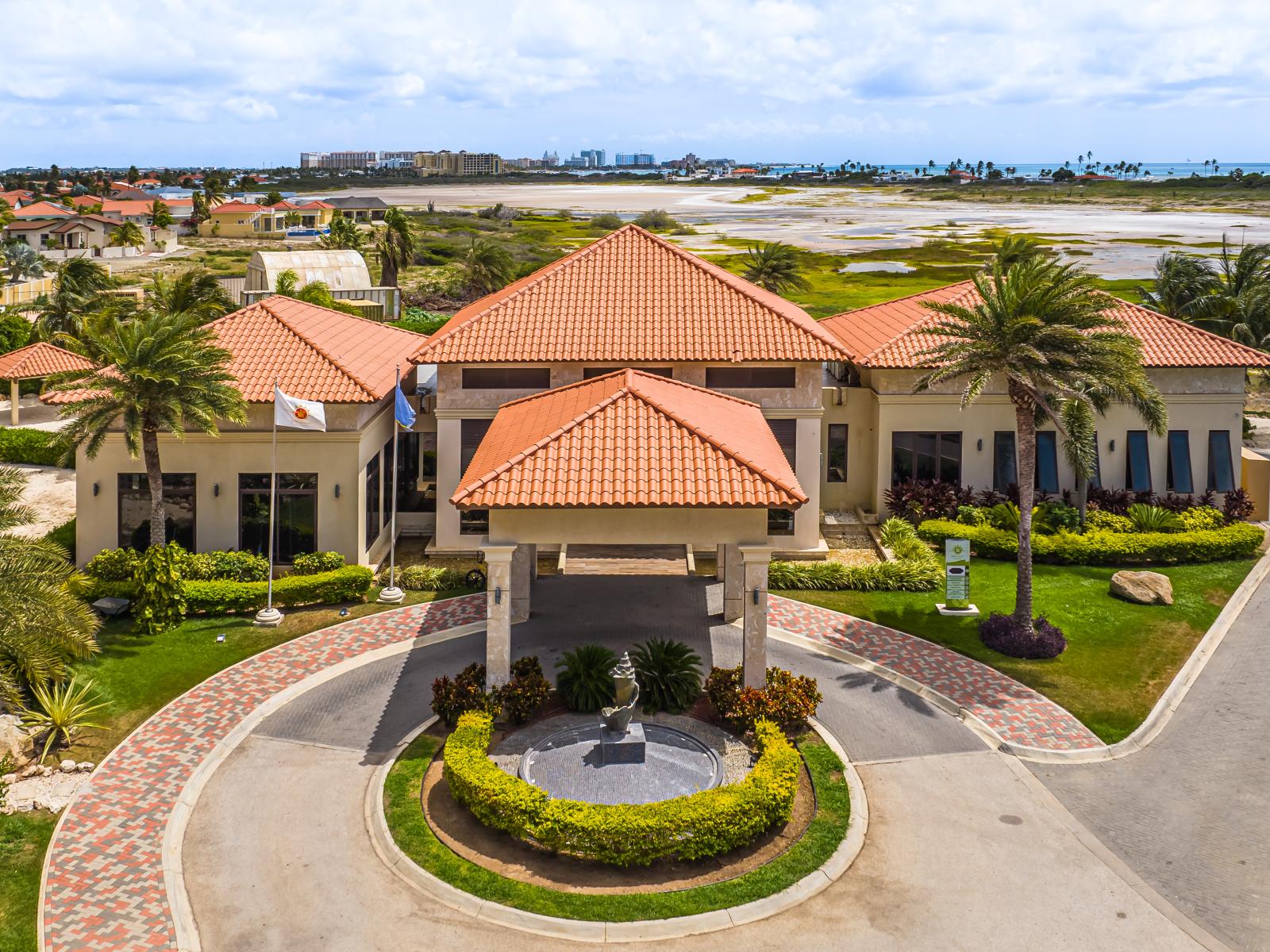 - Welcome to our resort, where the elegant exterior and impressive entrance set the tone for a luxurious stay in Noord, Aruba - Experience a warm welcome at our resort's beautifully crafted entrance, leading you into an oasis of comfort.