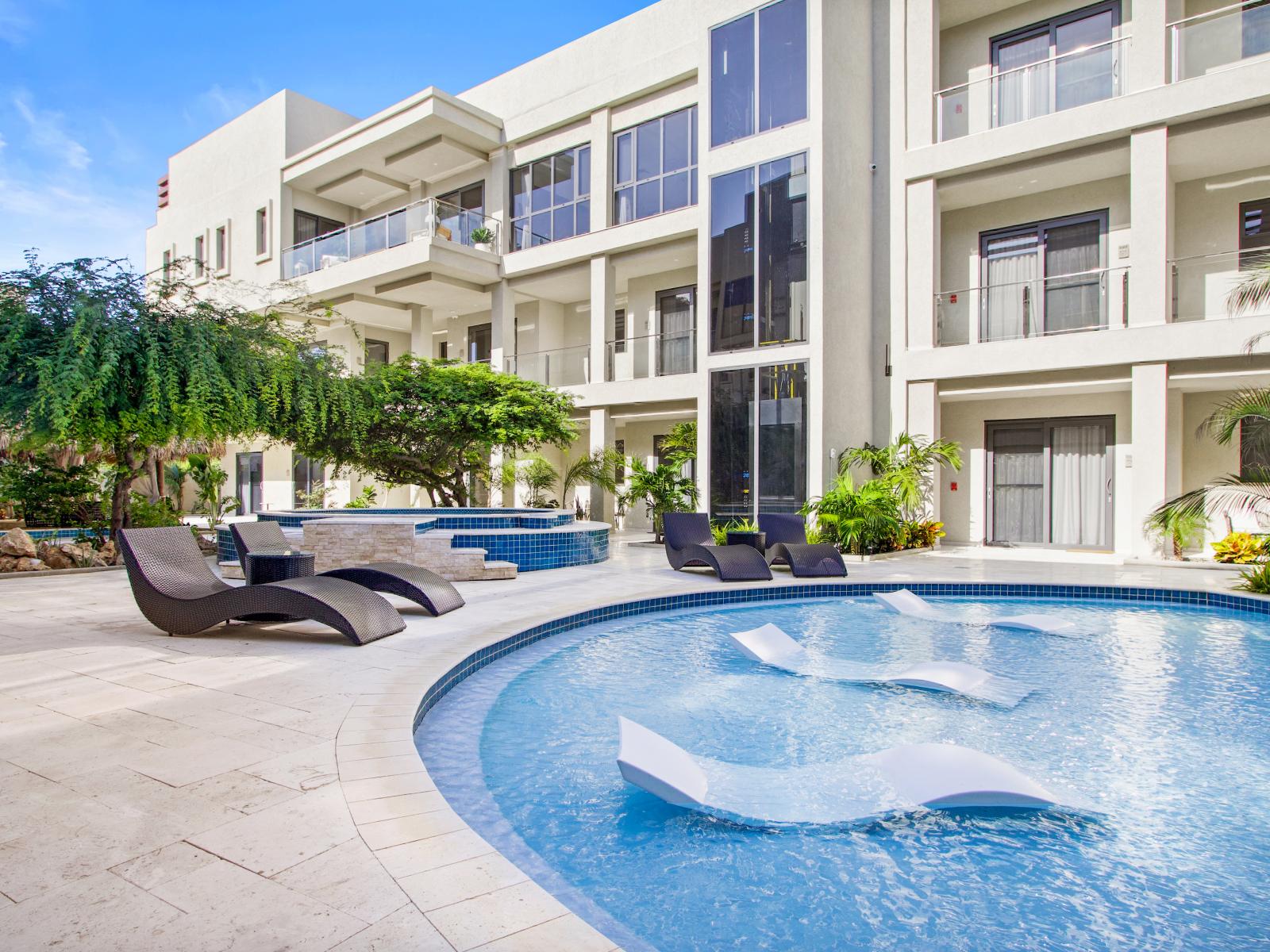 Serenity by the water's edge – our poolside lounge chairs await.