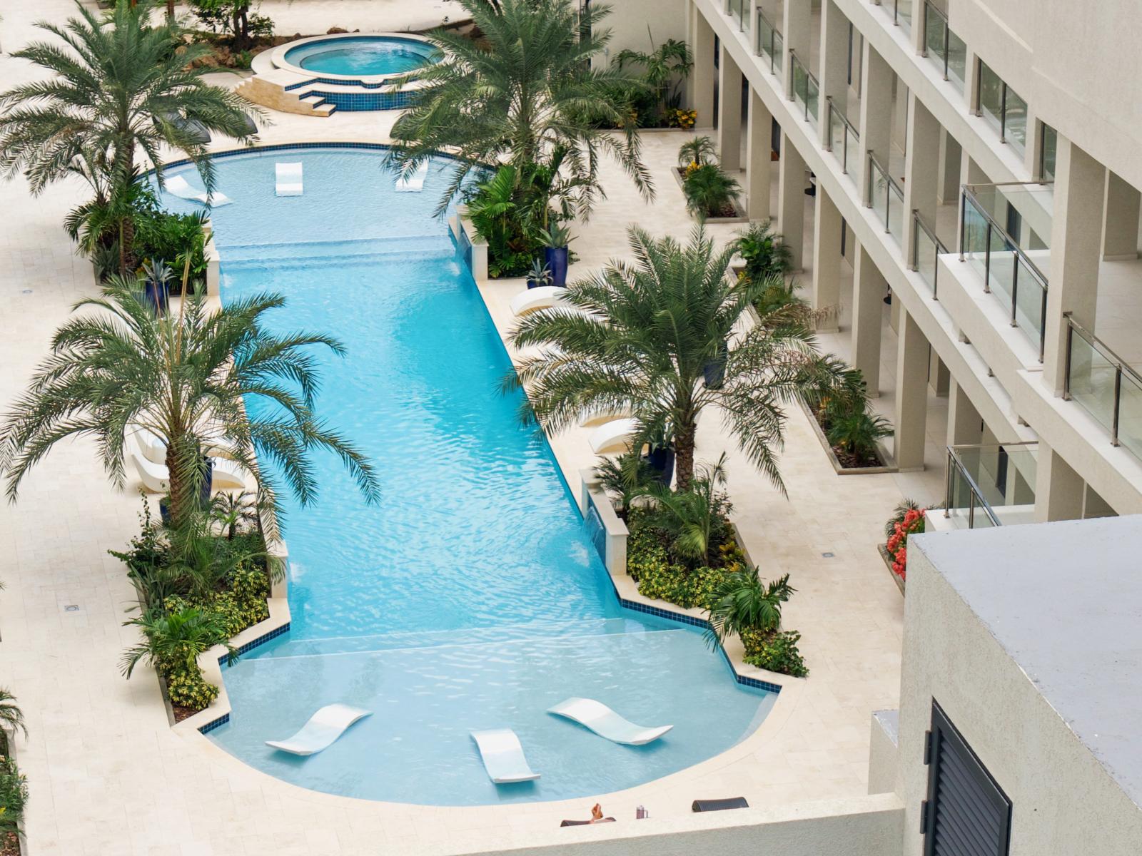 Dive into the lap of luxury – an aerial view of our serene pool oasis.