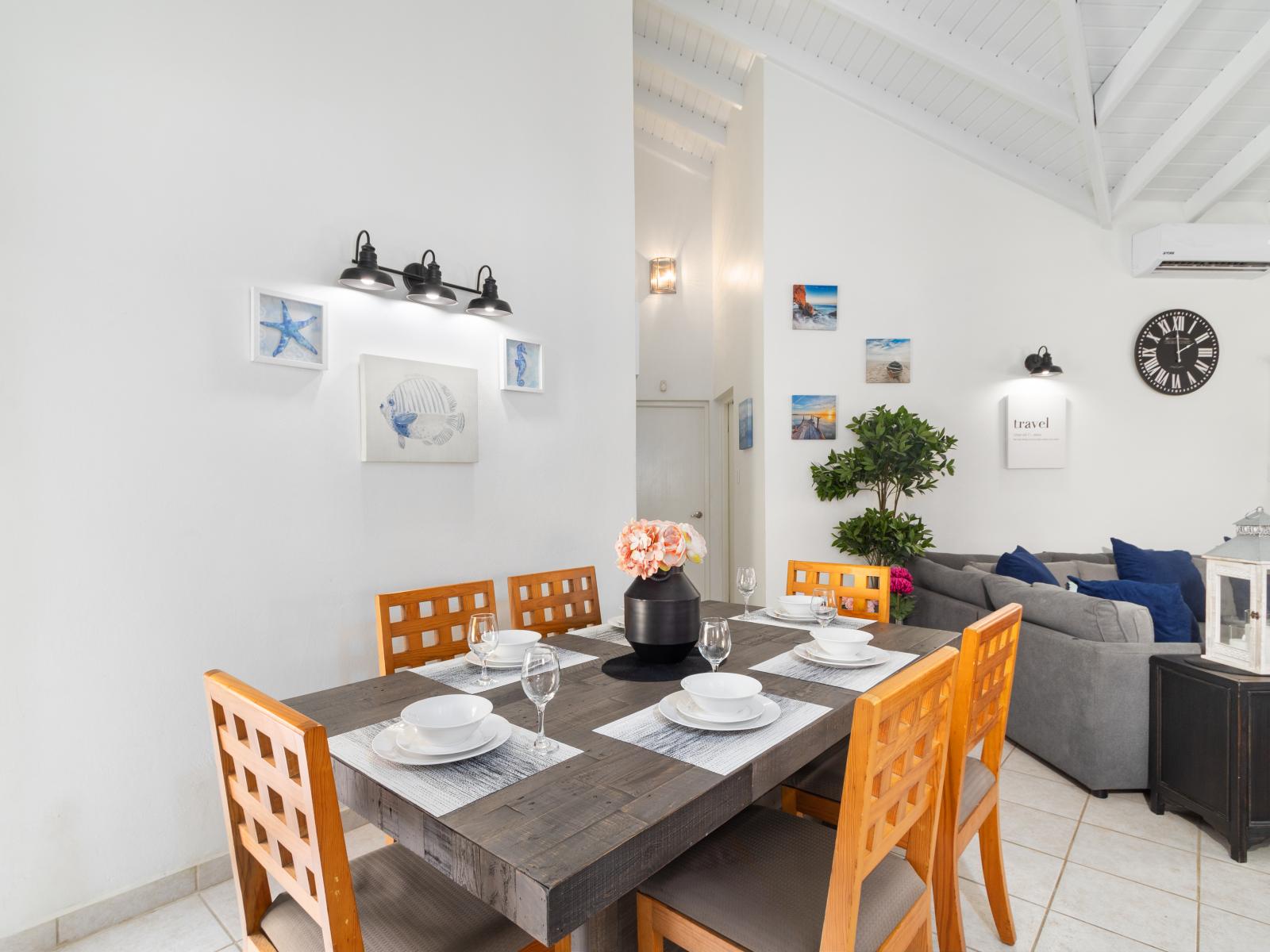 Marvelous dining area of the 2BR Home in Noord Aruba - Beautiful window facing dining area of the house - Elite 6 persons dinning - Stunningly located large windows with mesmerizing views - Majestic decored space with beautiful paintings