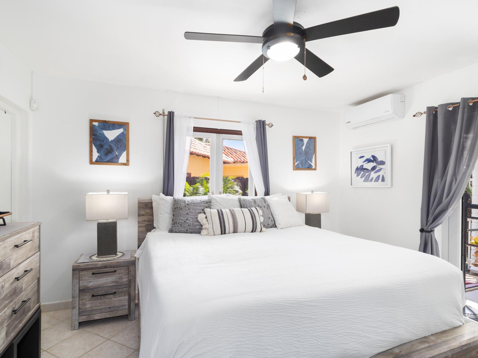 Exquisite bedroom of the 2BR Home in Noord Aruba - Comfy Double bed - Elegantly designed room - Beautiful painted walls with decoration - Majestic table lamps - Neat and clean linen - Large windows with beautiful views - TV and Netflix available