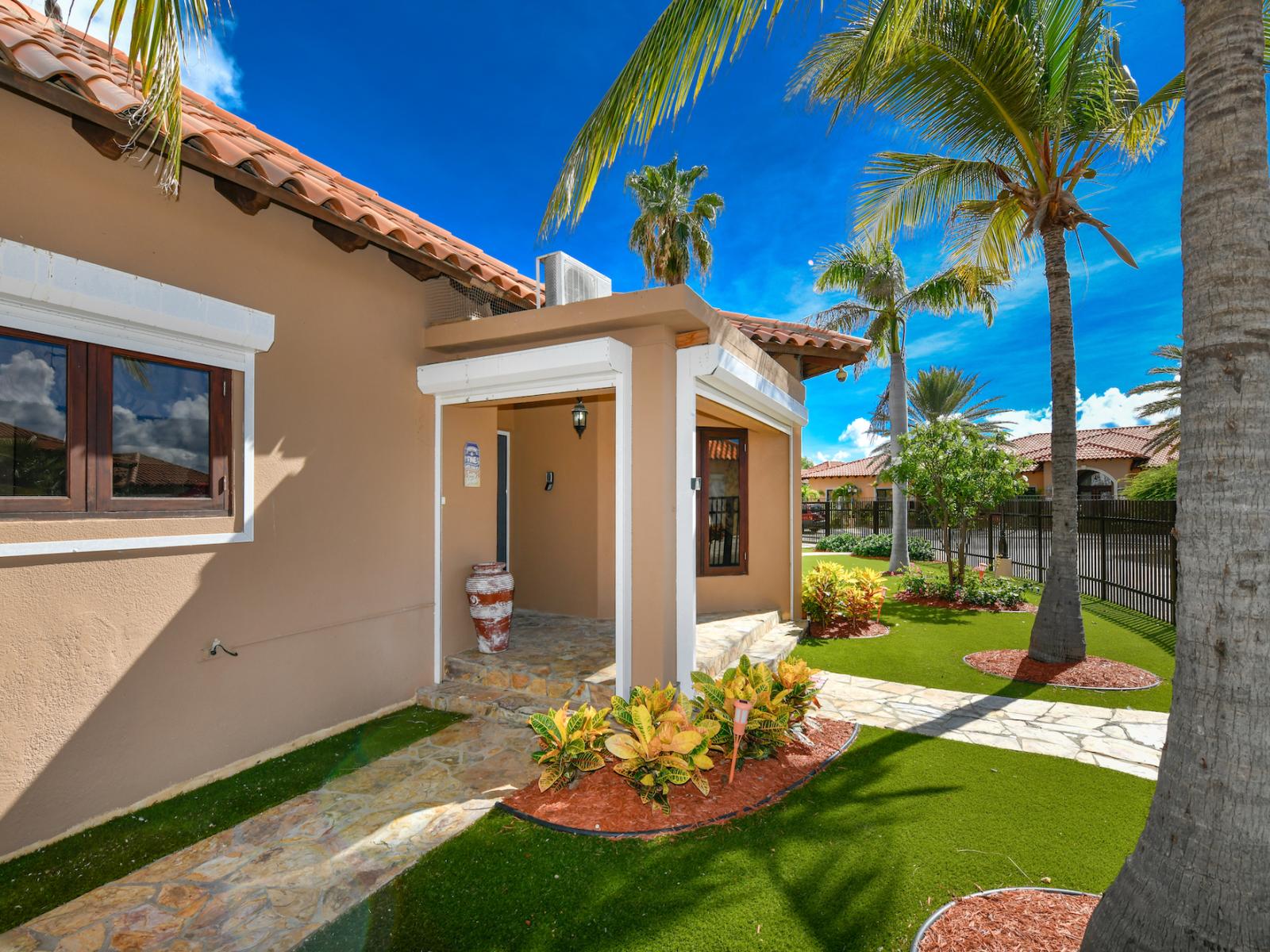 Inviting Entrance Area of the 2BR Home in Noord Aruba - Spacious entrance gate. - Breathe fresh air with our thoughtfully placed green companions