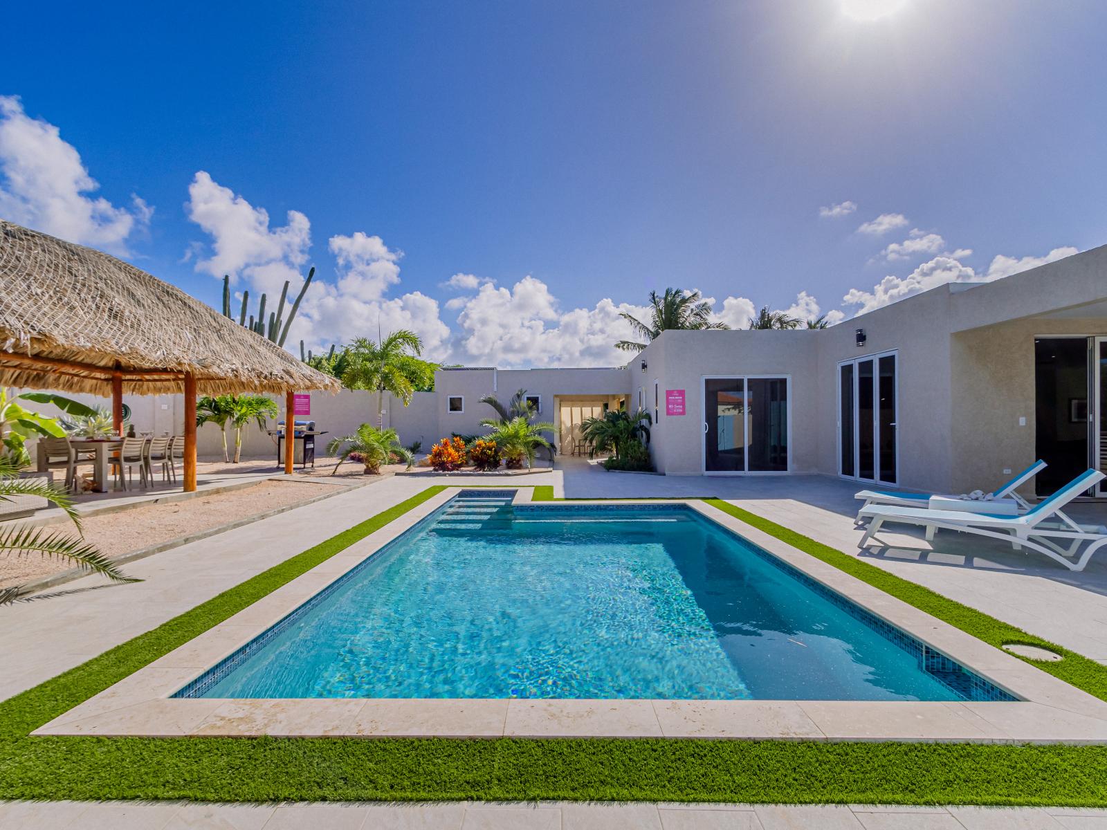 Luxury pool area of the 4BR Home in Noord, Aruba - Lush and refreshing environment - Cozy beach chairs available - Beautifully sunbathed space makes the soul peaceful  - Experience the comfort at the best