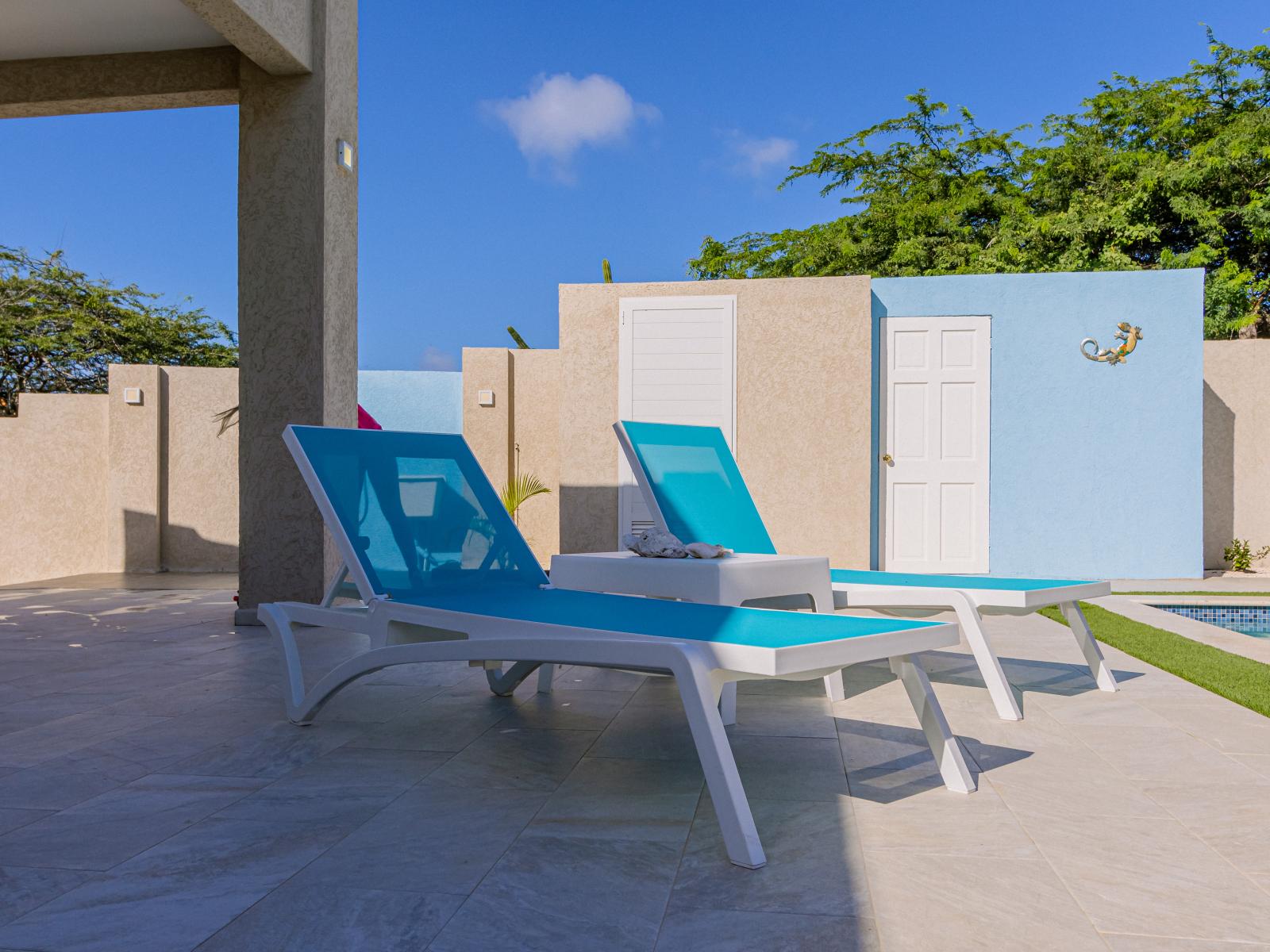 Lots of chairs by the pool for laying in the sun