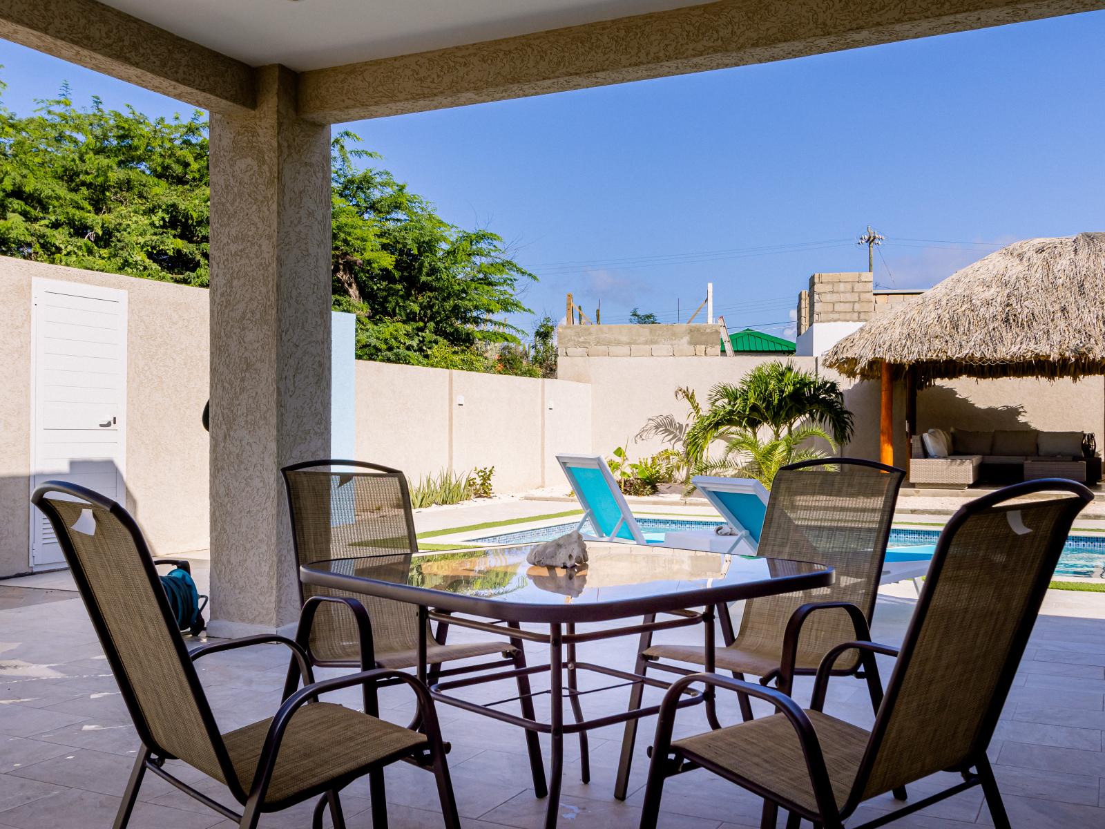 Dine in comfort and style by the pool in our inviting outdoor dining area, perfect for any time of day.