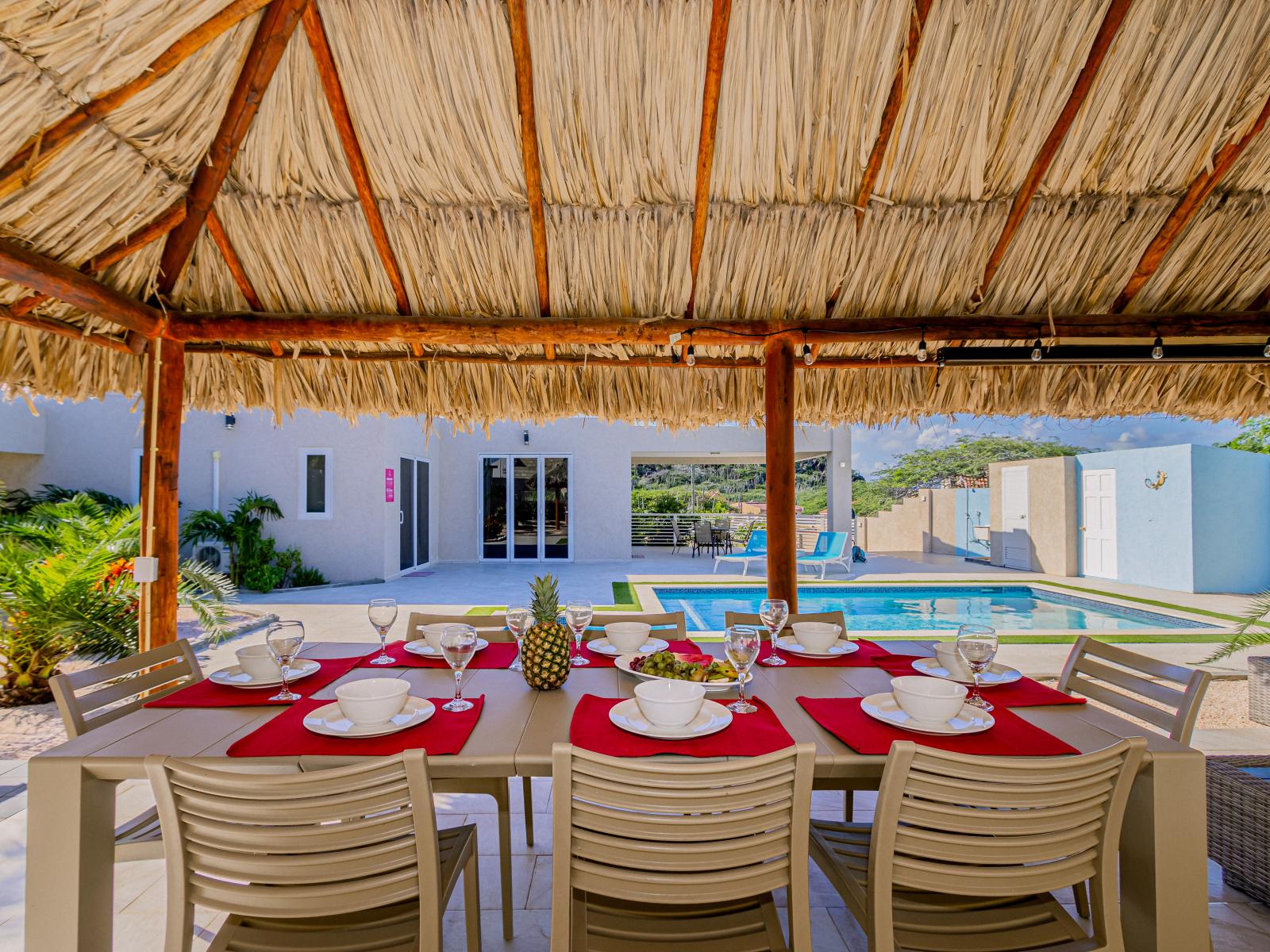 Large outdoor dining table next to the pool