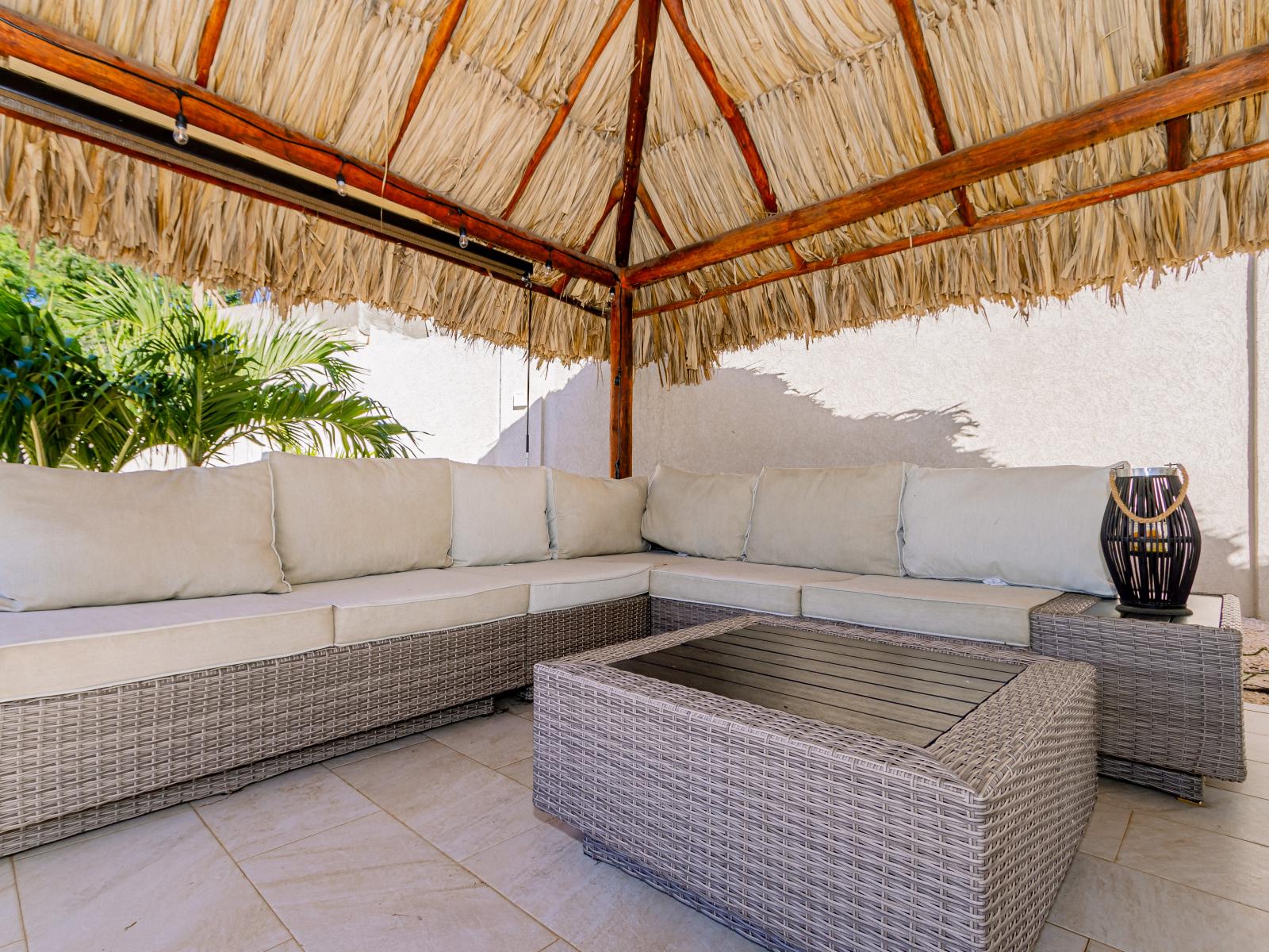 Polished Outdoor lounge of the 4BR Home in Noord Aruba - Elegantly blending tradition and modernity in its design - A picturesque avenue boasting timeless beauty - A place to relax and socialise