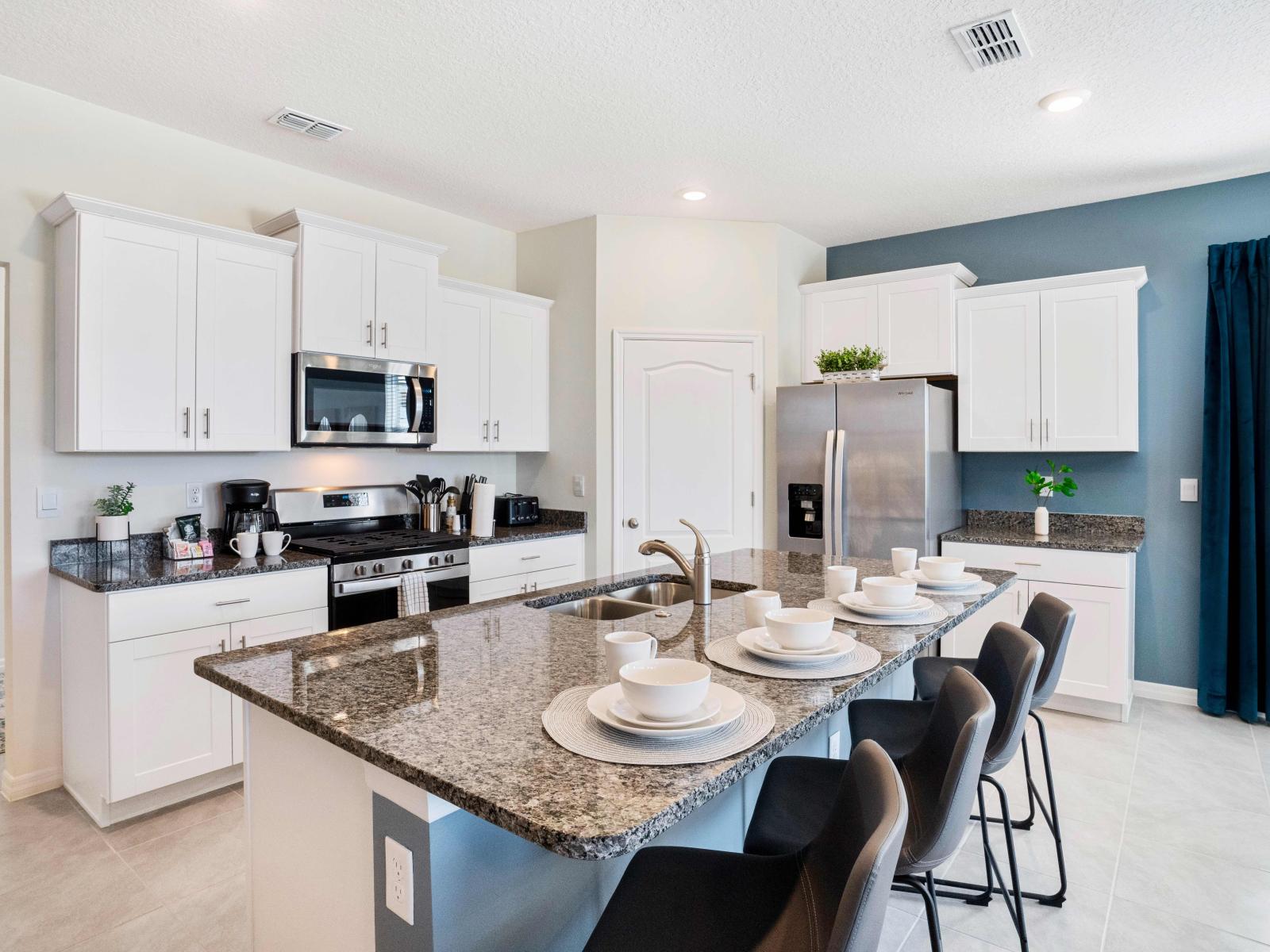 Sleek kitchen of the home in Davenport Florida - Fully equipped - Breakfast bar and high chairs - Harmonious blend of practicality and contemporary aesthetics