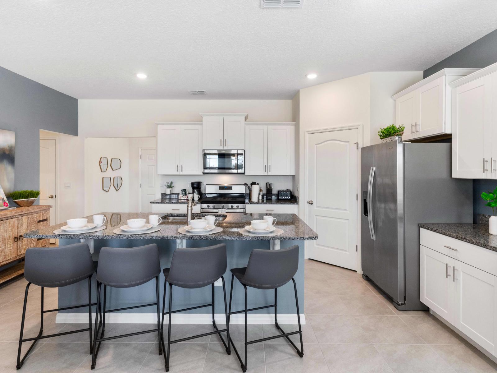 Modern kitchen of the home in Davenport Florida - Integrated appliances for a seamless and stylish appearance - Thoughtful placement of kitchen essentials for easy access - Inviting atmosphere