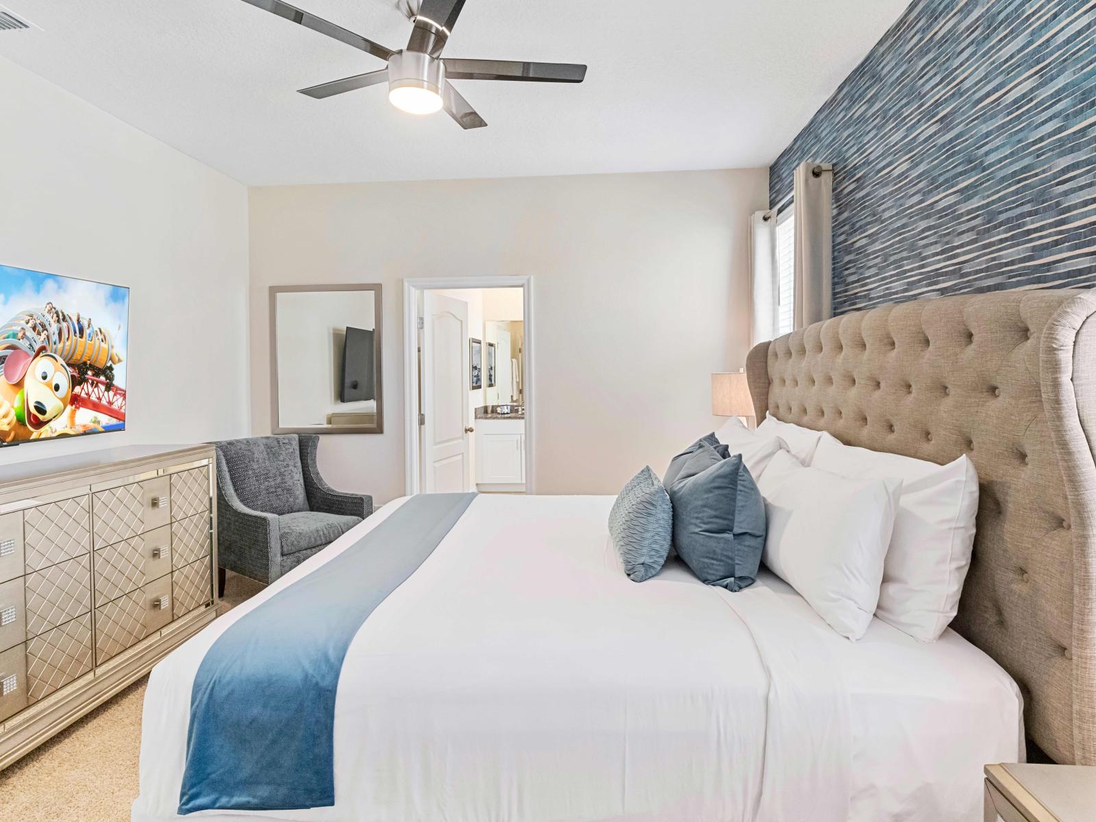 Indulge in the comfort of our master bedroom (King Suite) equipped with a luxurious king-size bed and a flat-screen TV. This room provides a perfect retreat with modern amenities and ample space.