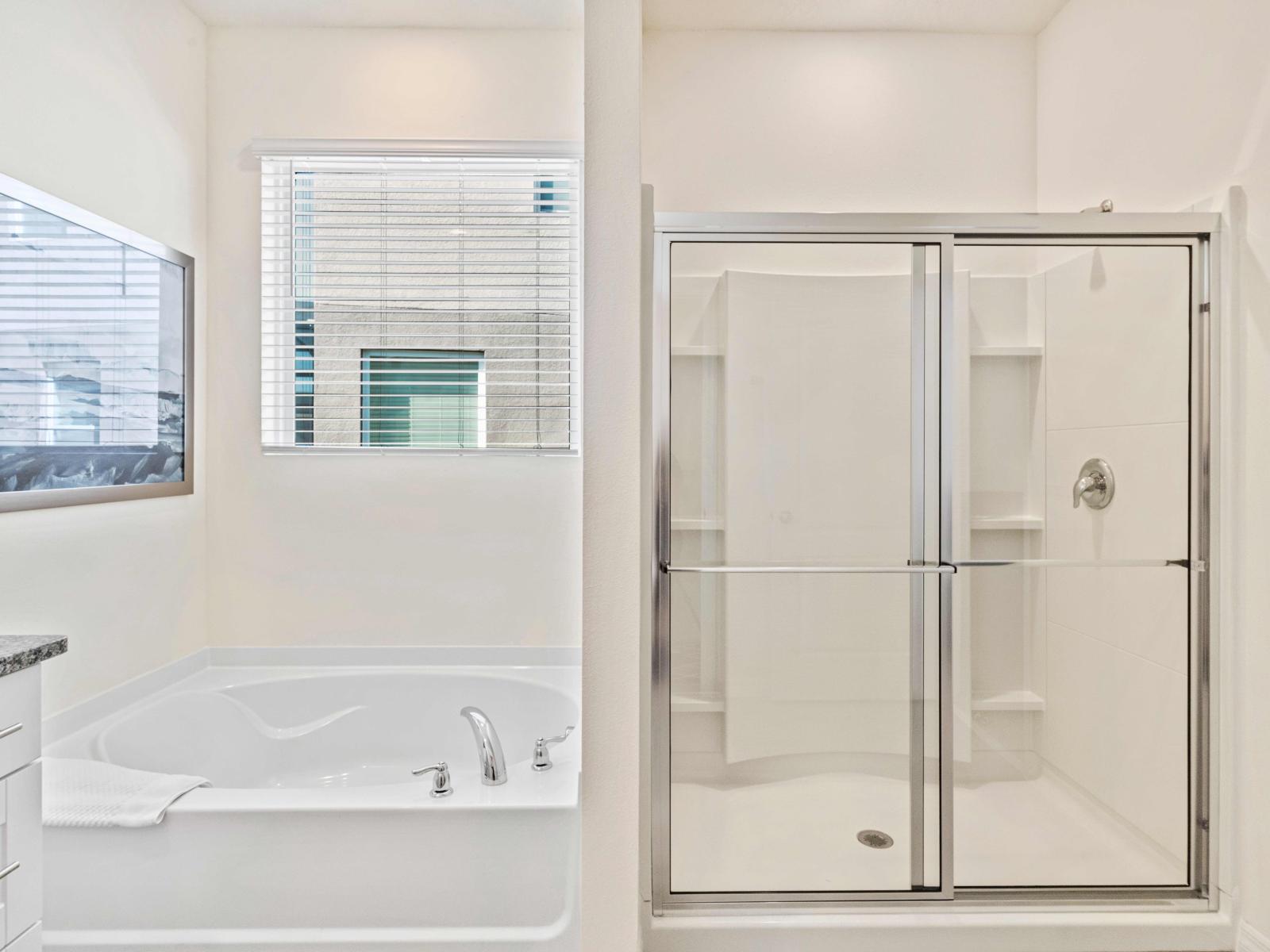 Spacious master en-suite with both a walk-in shower and a soaker tub. This elegant bathroom offers a perfect blend of comfort and style, ideal for unwinding after a busy day.