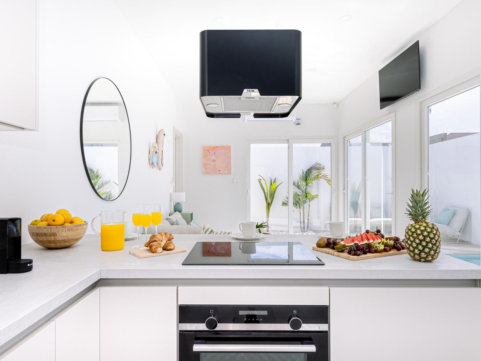 Modern kitchen of the Home in Oranjestad Aruba - Kitchen with stainless steel appliances - Integrated appliances for sense of spaciousness - Smart TV and Netflix