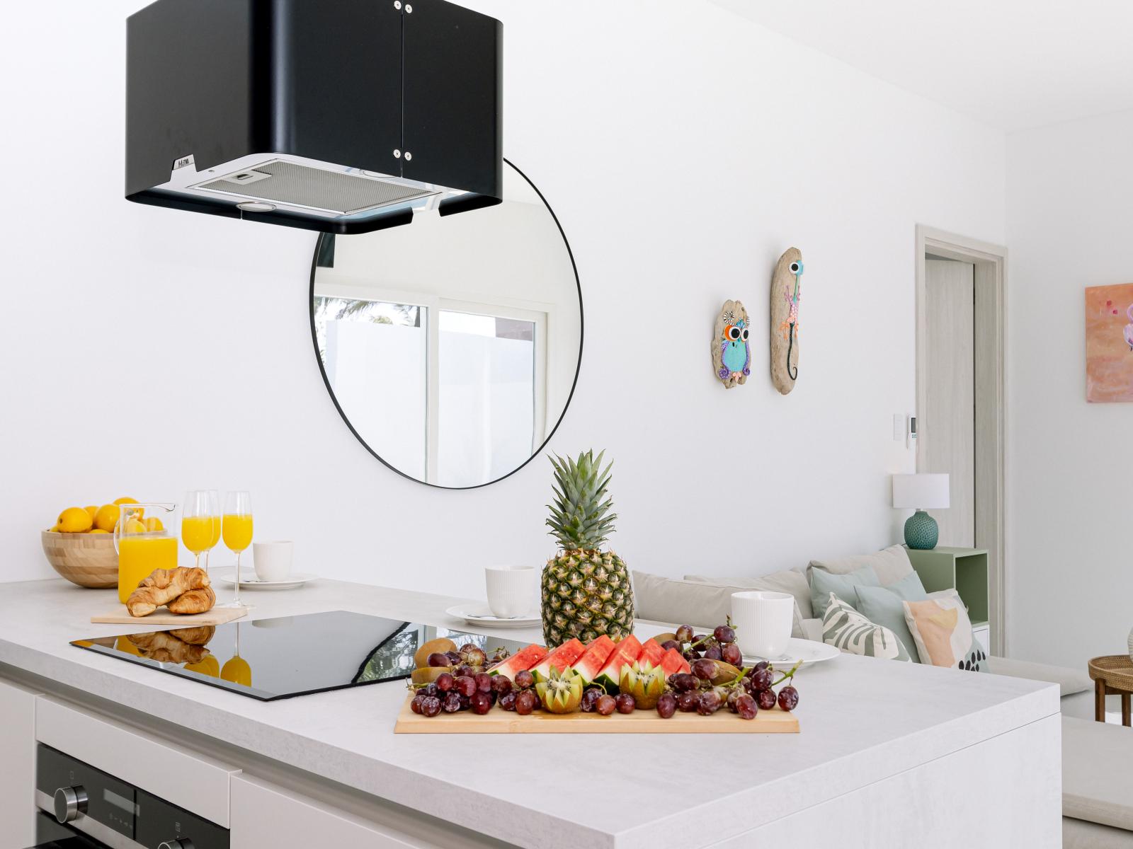 Wealthy Kitchen of the Home in Oranjestad Aruba - Kitchen ready for you to enjoy meals with family - Modern Stove top - Stylish round shape mirror