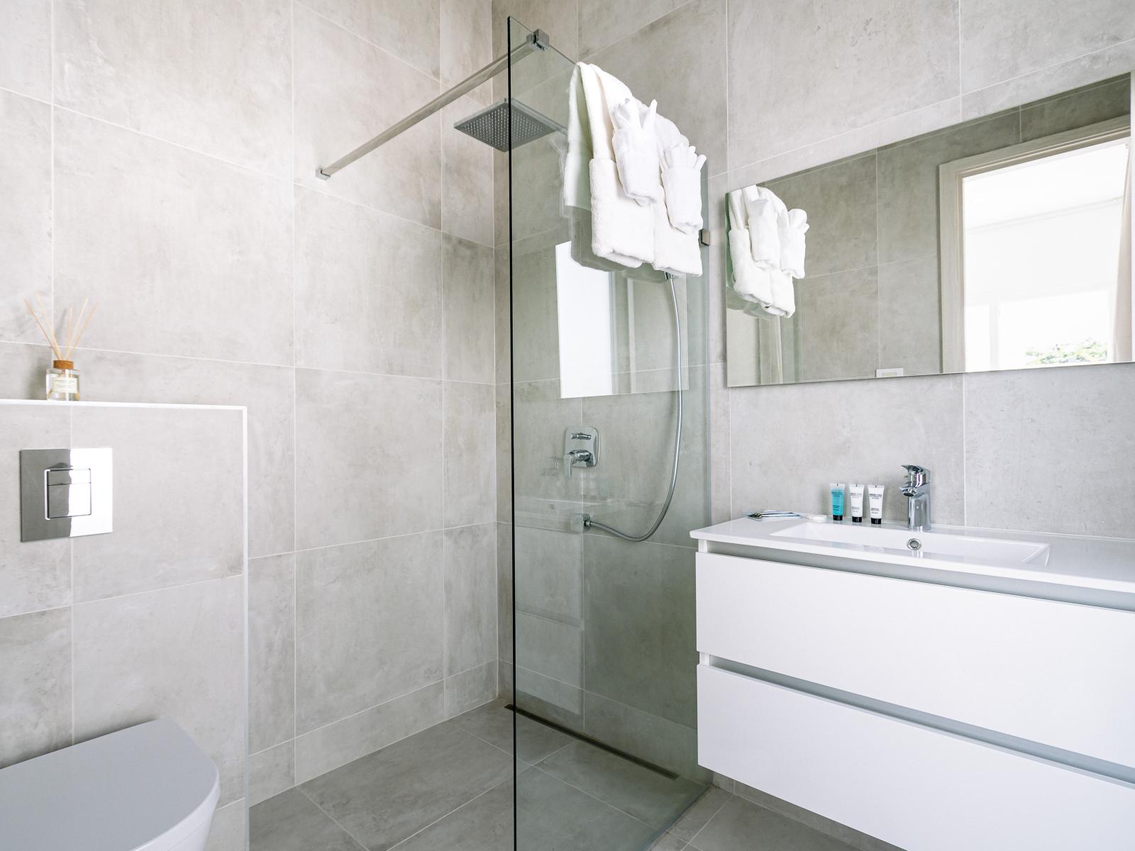 Polished Bathroom of the Home in Oranjestad Aruba - Chic Vanity with large mirror - Walk-in Shower Area - Neat and Clean