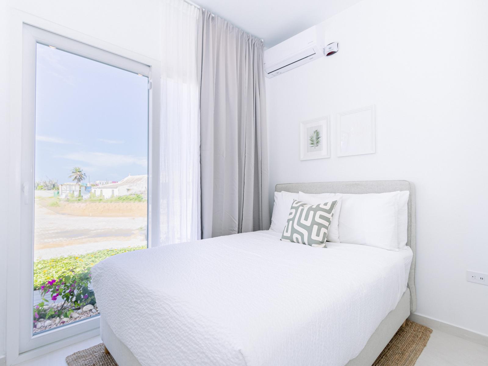 Calming Bedroom of the Home in Oranjestad Aruba - Queen size bed - Plenty of closet space - Modern bedroom with sleek design and natural light