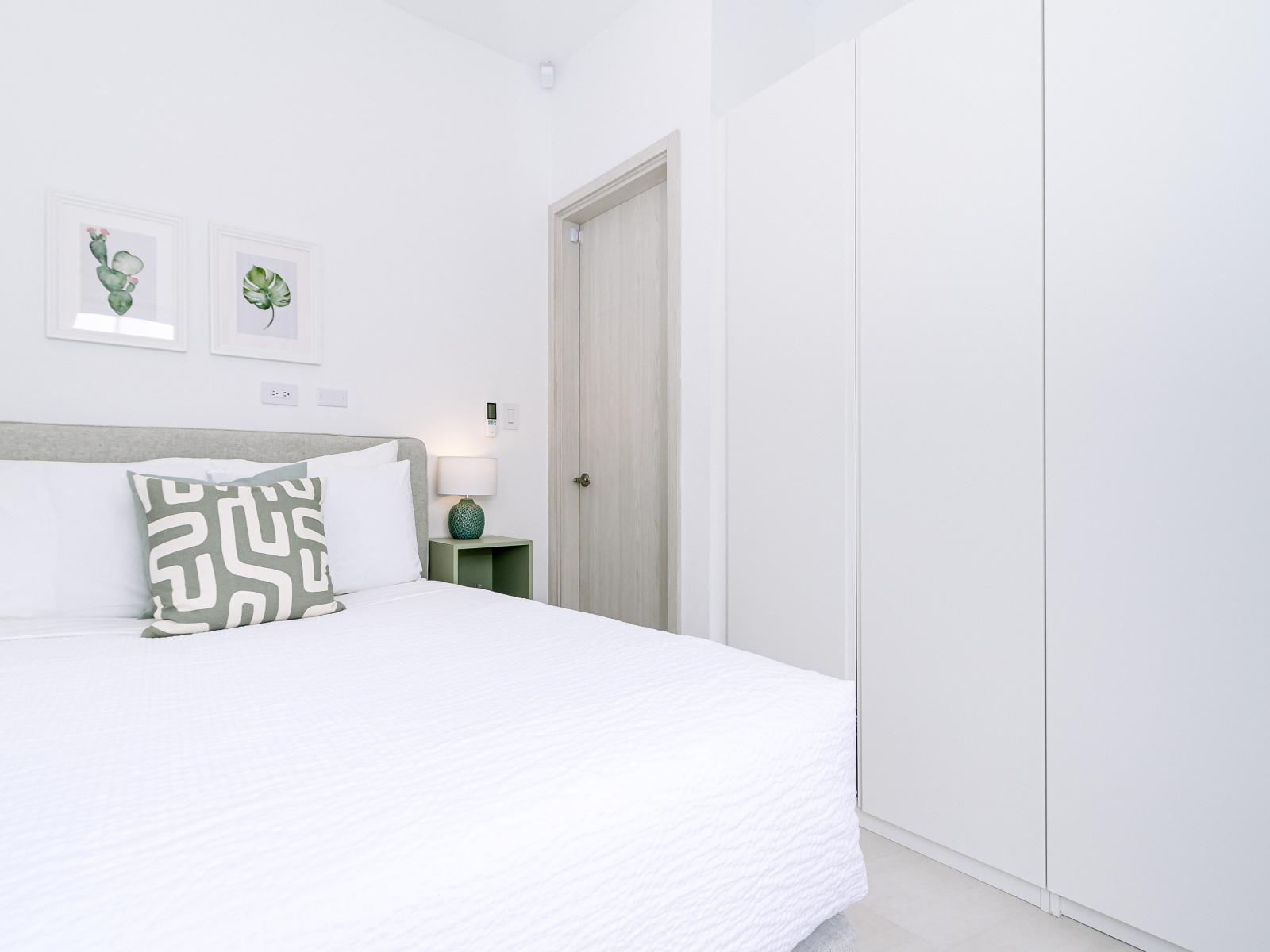 Relaxing Bedroom of the Home in Oranjestad Aruba - Comfy Double bed - Modern and stylish decor that complements the space - Full size wardrobe - Luxurious bedding for a restful night's sleep