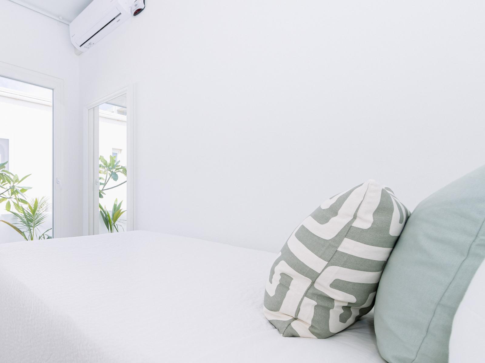 Modern Bedroom of the Home in Oranjestad Aruba - Sliding glass doors for easy access to the outdoors  - Black out curtains for relaxation - Comfy bed