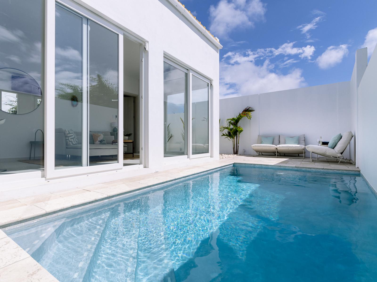 Refreshing Pool Area of the Home in Oranjestad Aruba - Lush Pool Area  - Unwind with a dip in our chic and stylish pool area - Comfortable lounge chairs for ultimate relaxation