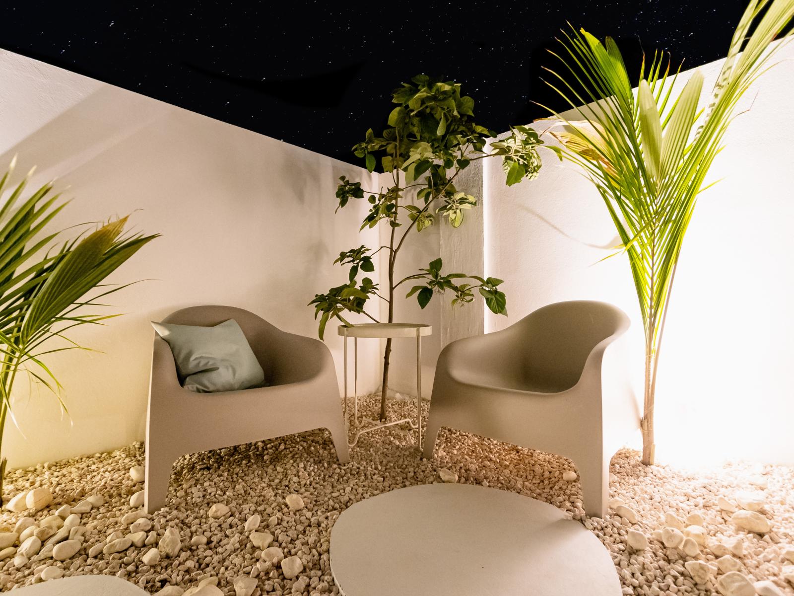 Cozy outdoor Seating of the Home in Oranjestad Aruba - Artfully arranged plants for a touch of nature -  Seating for enjoyable gatherings - Outdoor seating at Night makes for a romantic scene