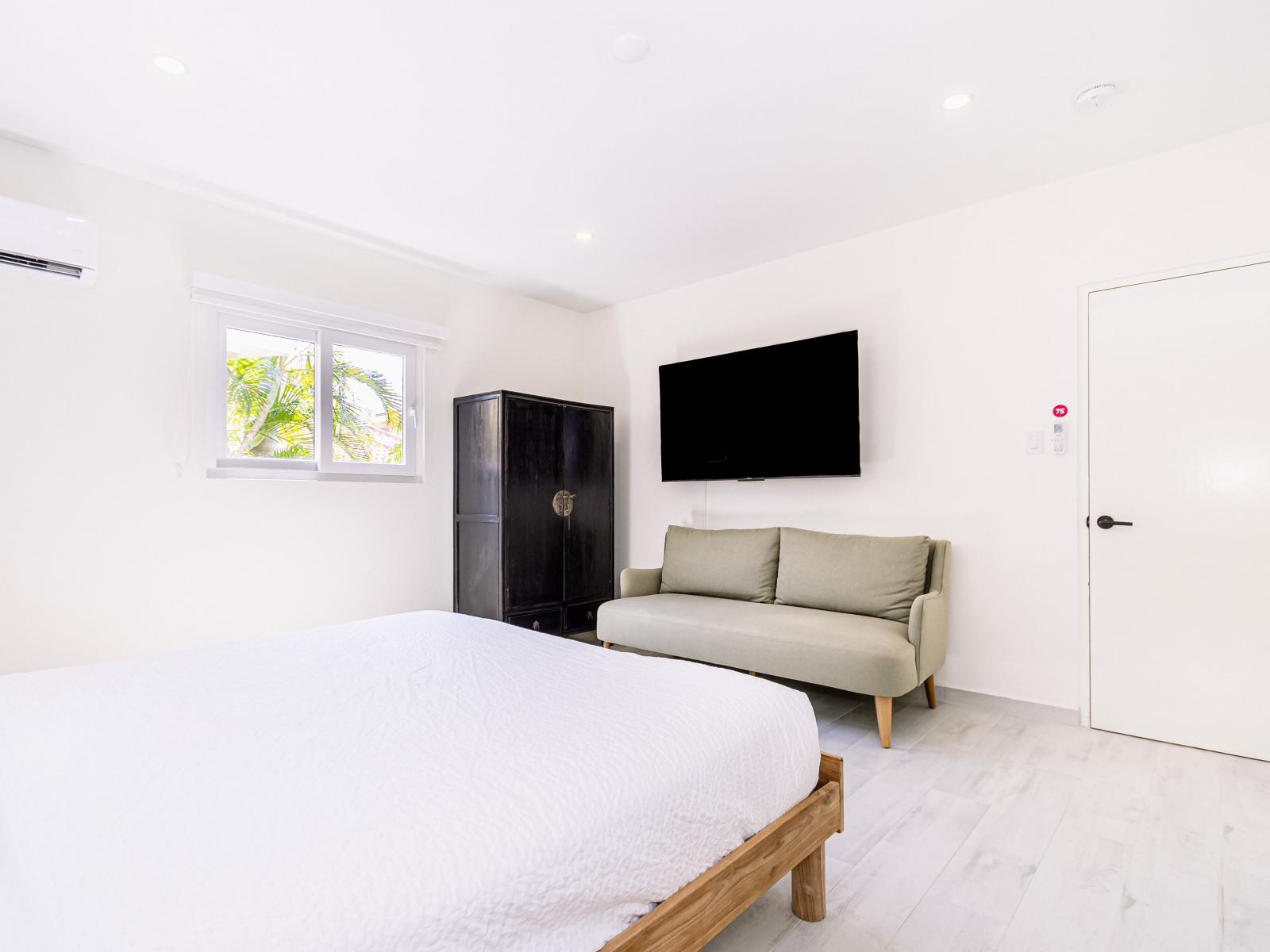 Relax in Bedroom 1, complete with a wall-mounted flat-screen TV for your entertainment and relaxation.