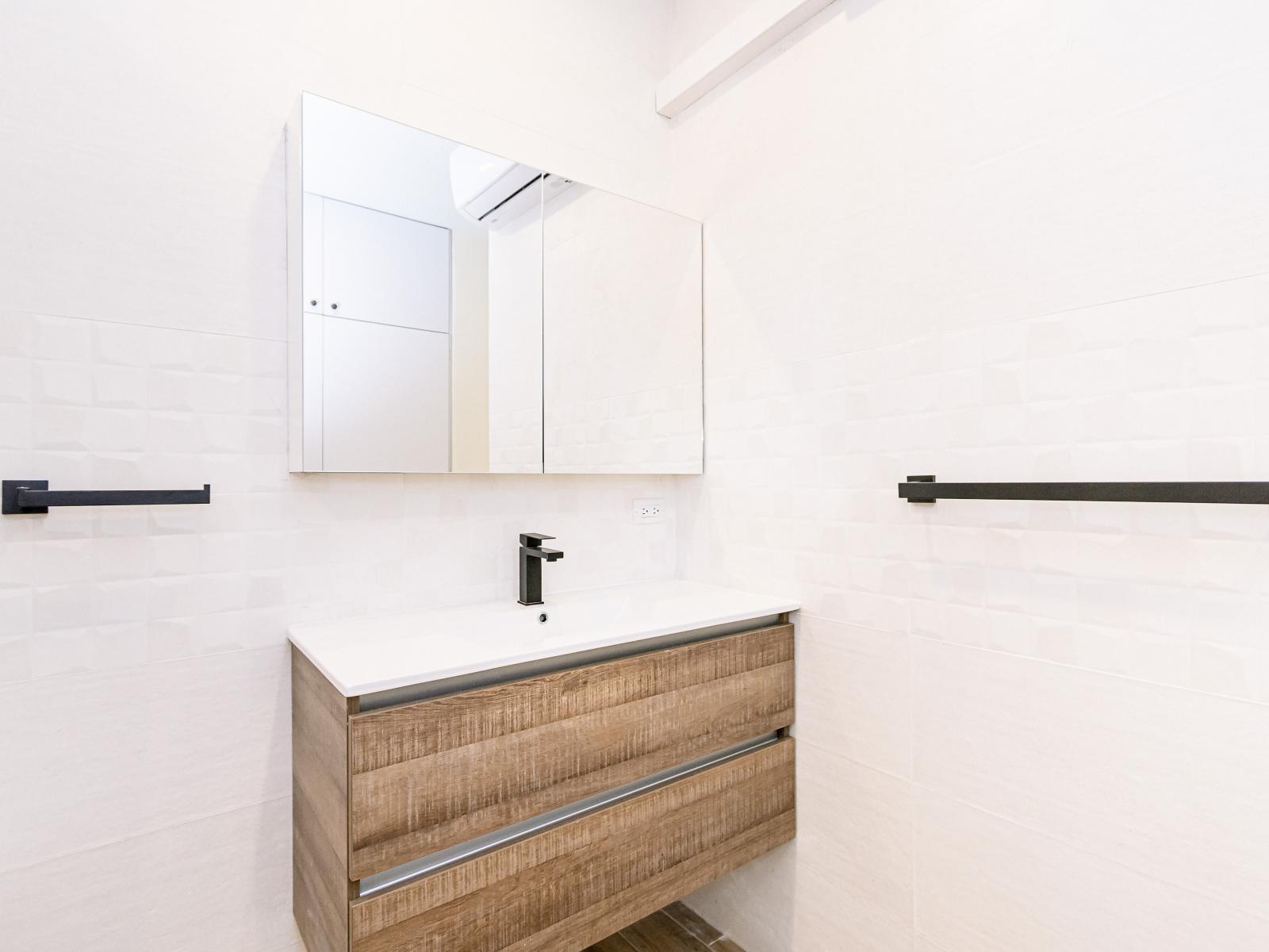 Experience the elegance of Bathroom 1, boasting a spacious walk-in shower that combines style with comfort.