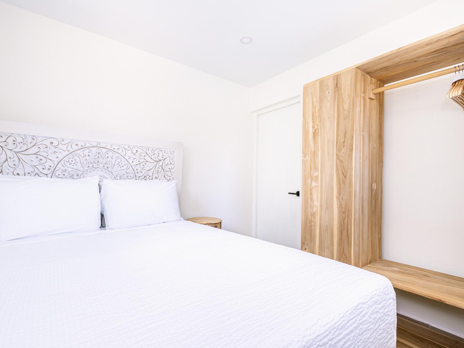 Lavish Bedroom of the Villa in Noord, Aruba - Cosy Bed with soft pillows and neat and clean bedsheet - Stunning large wardrobe with ample hanging space - Elegantly designed bed - Majestic lighting - Availability of TV and Netflix