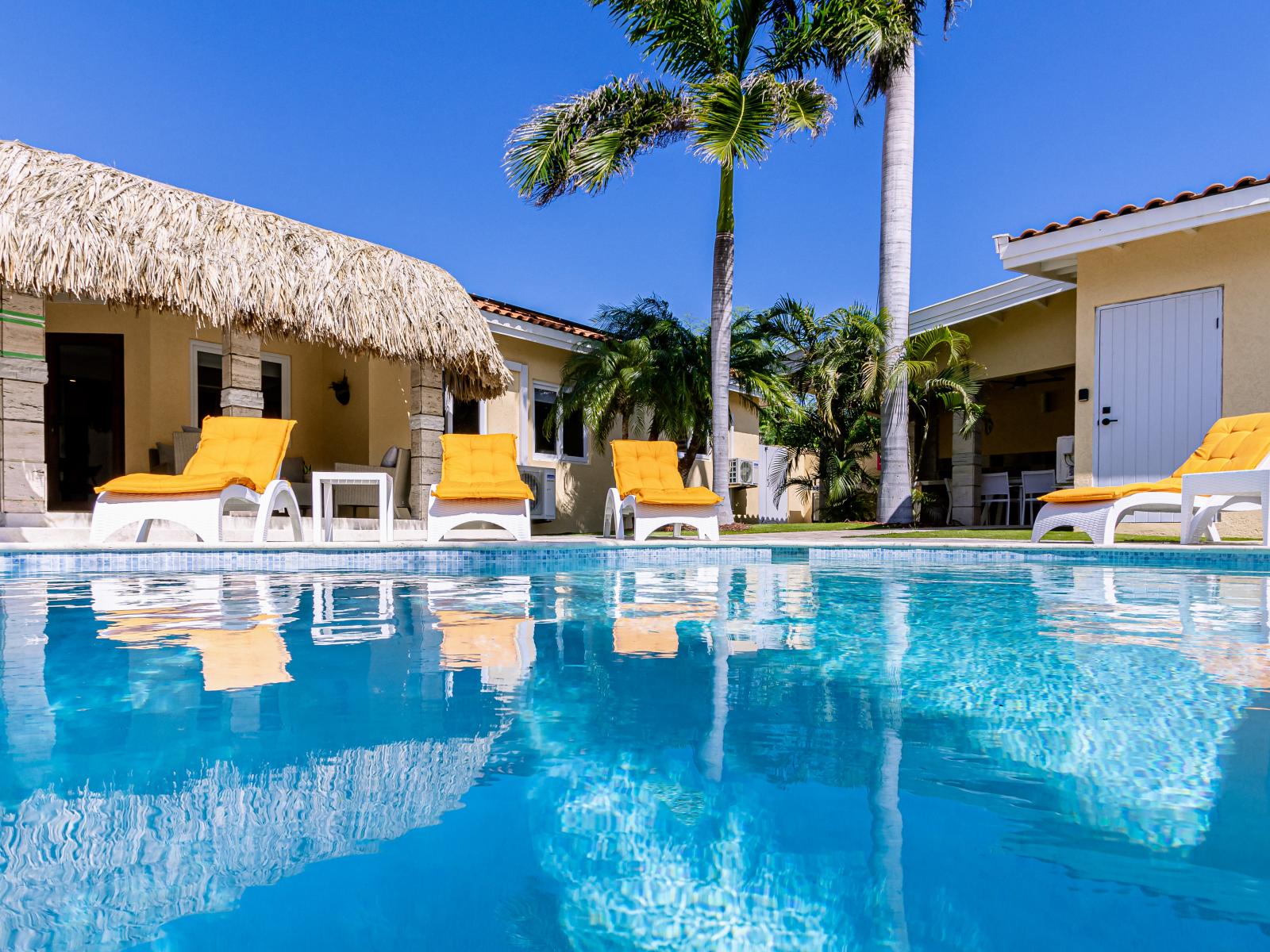 Relax and soak up the sun with plenty of poolside chairs available for lounging and enjoying the day.