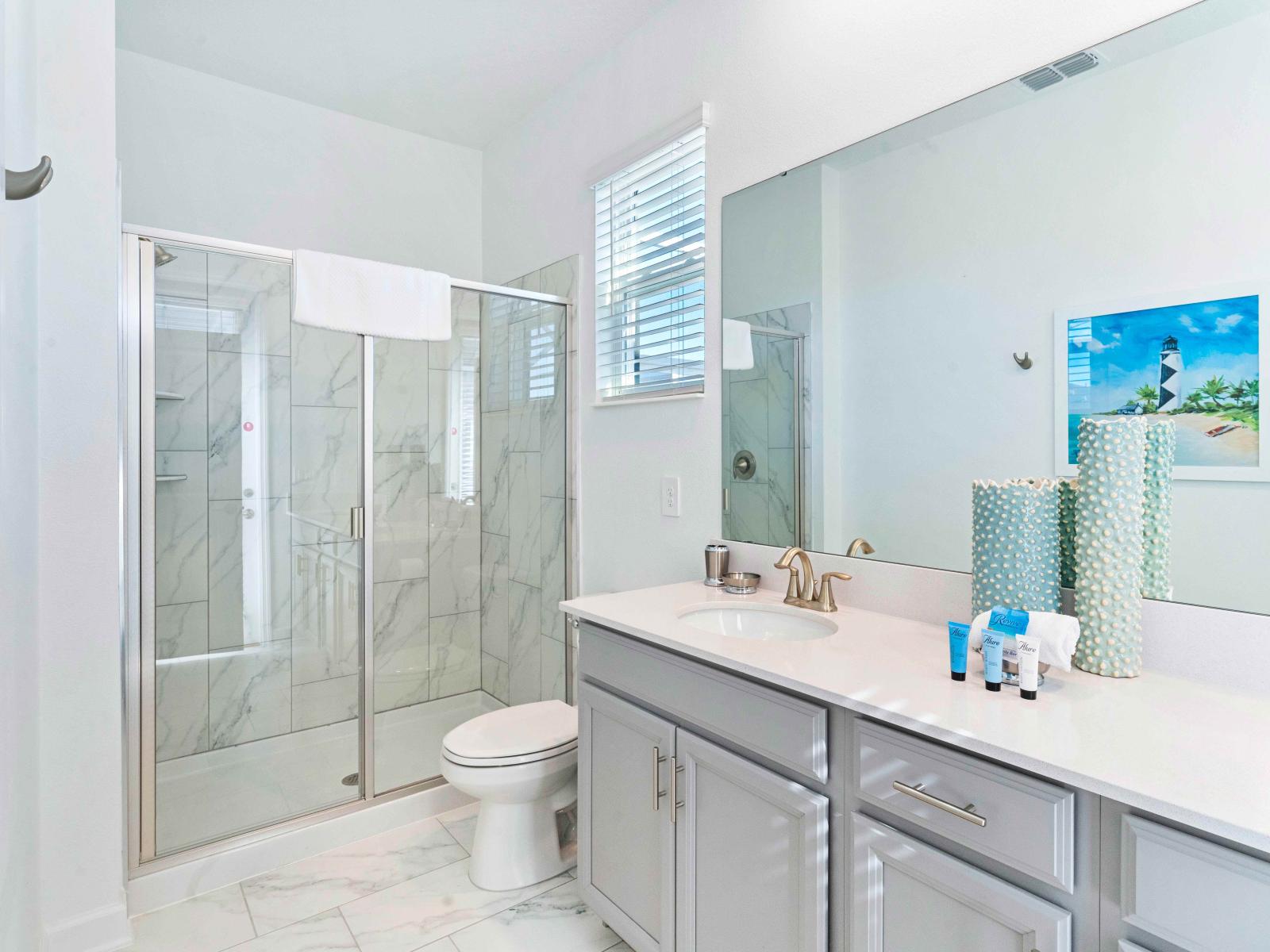 Luxe Bathroom of the Townhouse in Davenport Florida - Discover the pinnacle of tranquility - Complete with a luxurious and a sleek walk-in shower for a spa-inspired retreat - Lush vanity with large mirror and plenty of storage