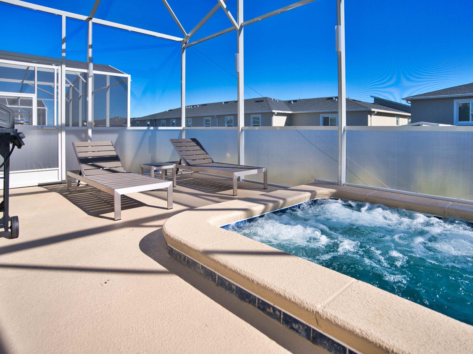 Refreshing Private Pool Area of the Townhouse in Davenport Florida - Comfortable lounge chairs for ultimate relaxation - Immerse yourself in luxury with a soothing soak in our outdoor Jacuzzi