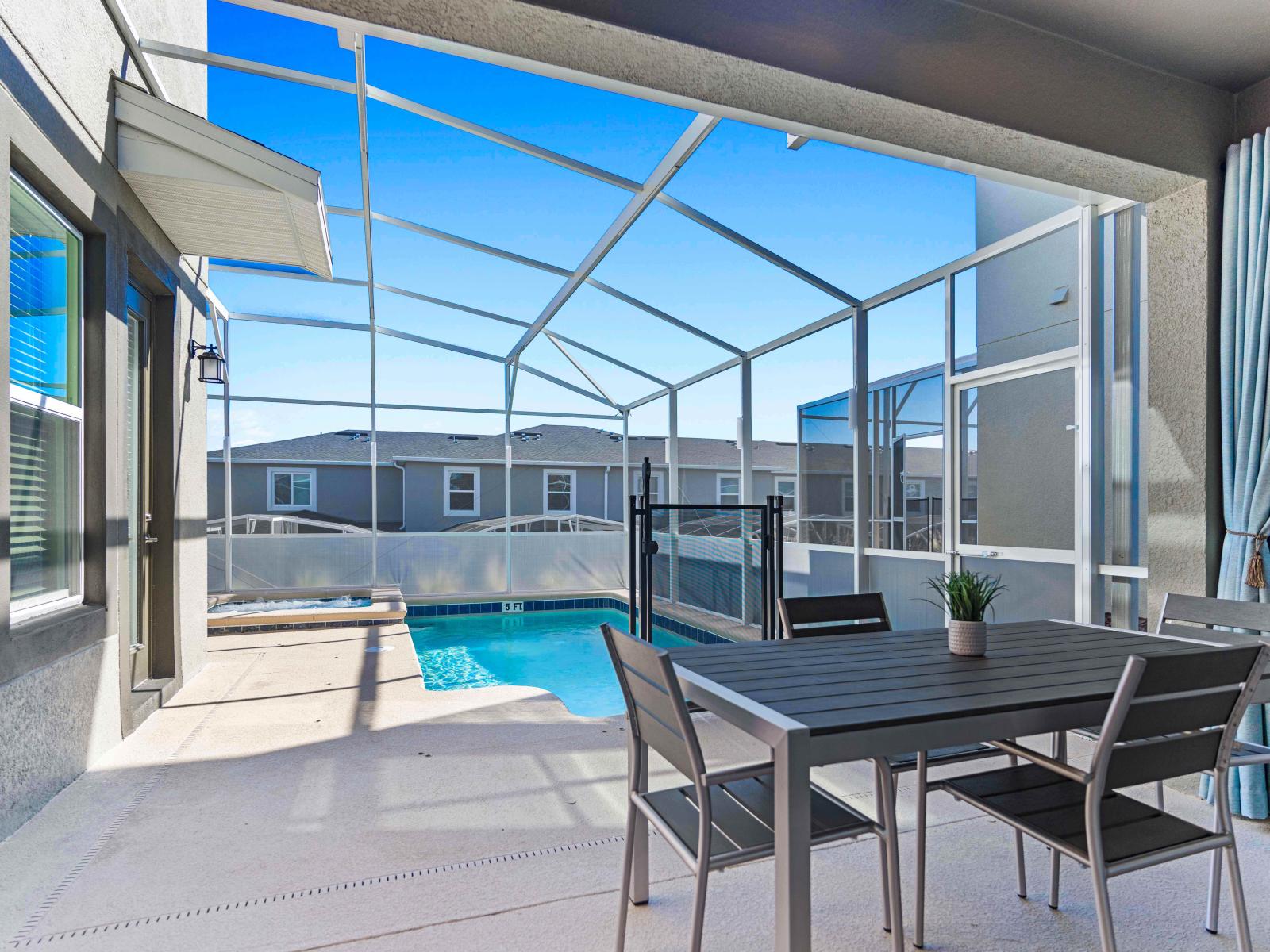 Amazing Outdoor Dining Area of the Townhouse in Davenport Florida - Dining Elegance by the Pool - Experience the epitome of luxury dining with exquisite setup - Offering a direct view of the sparkling outside pool