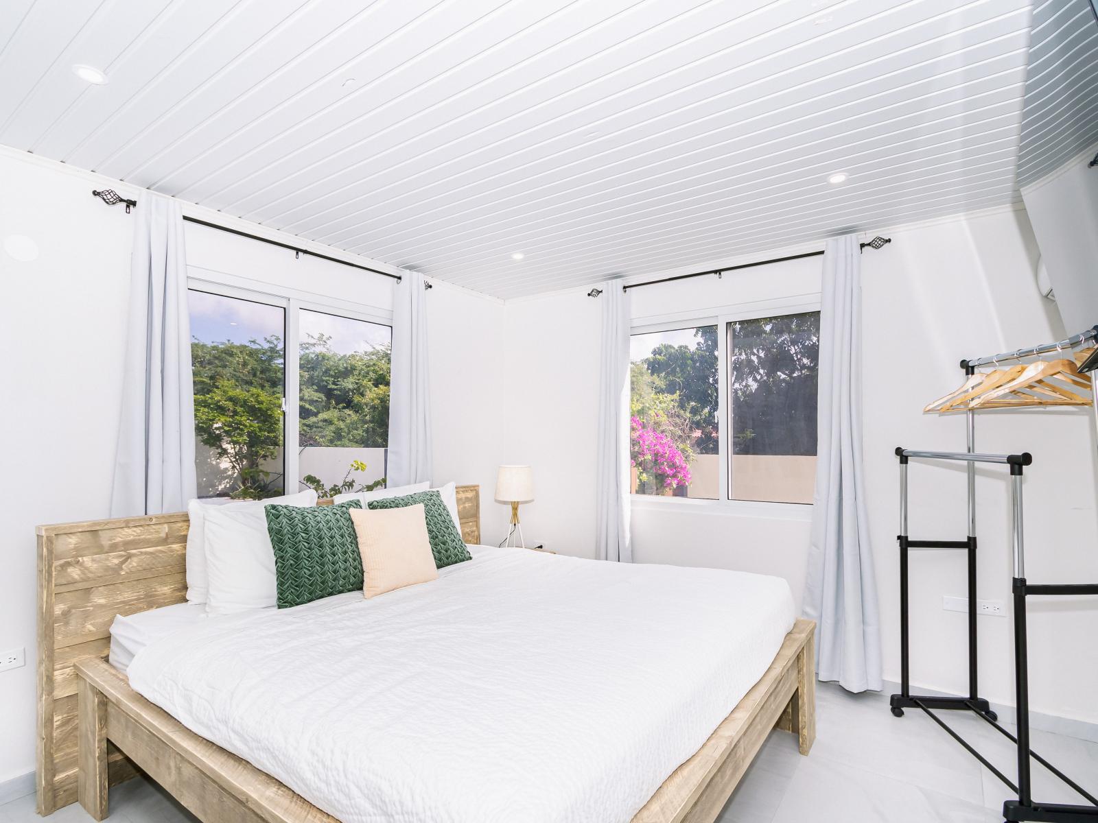 Main bedroom 1 features a King size bed and a wall mounted flat screen TV