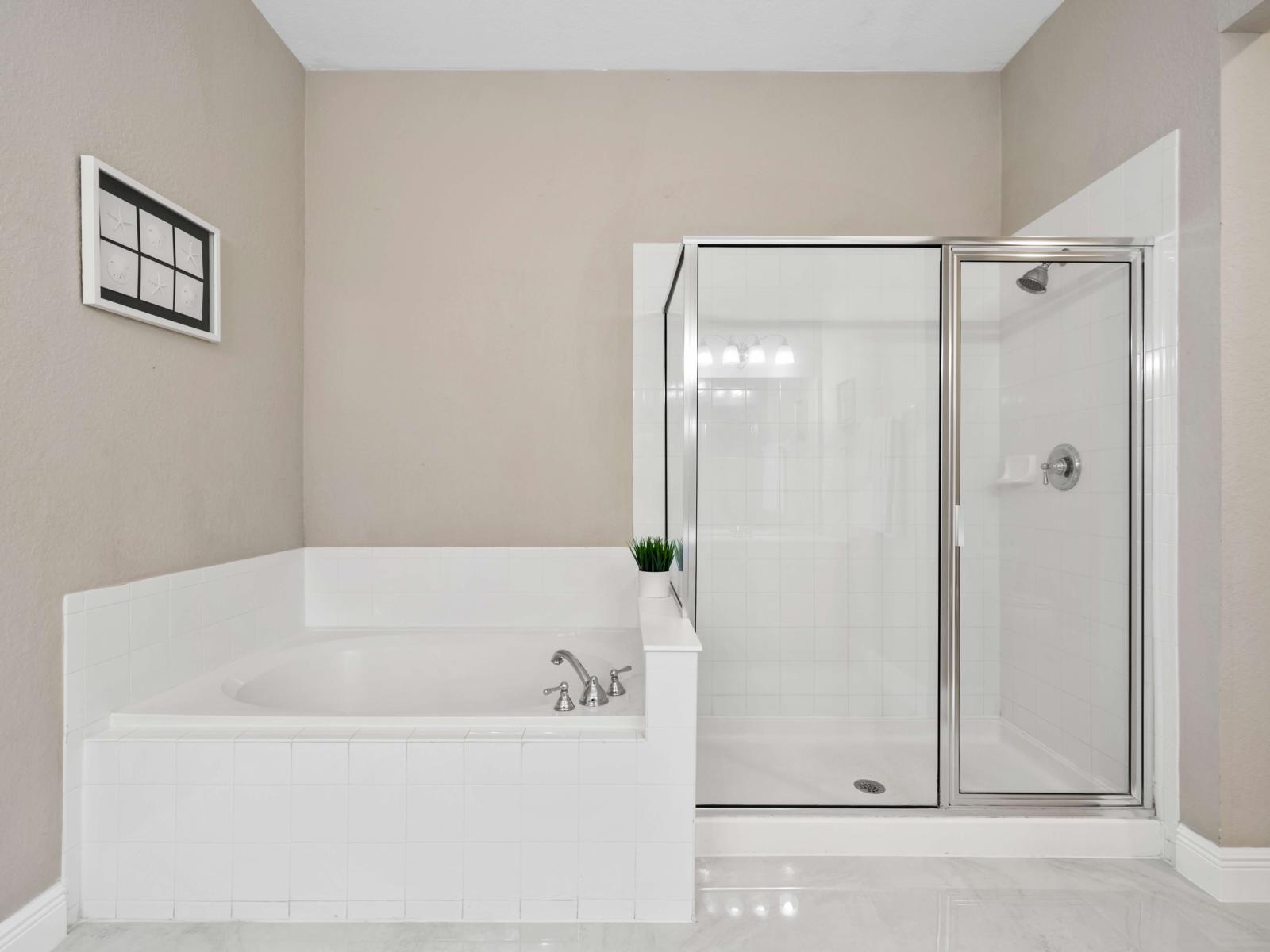 Private bathroom suite with a bathtub and a walk- in shower