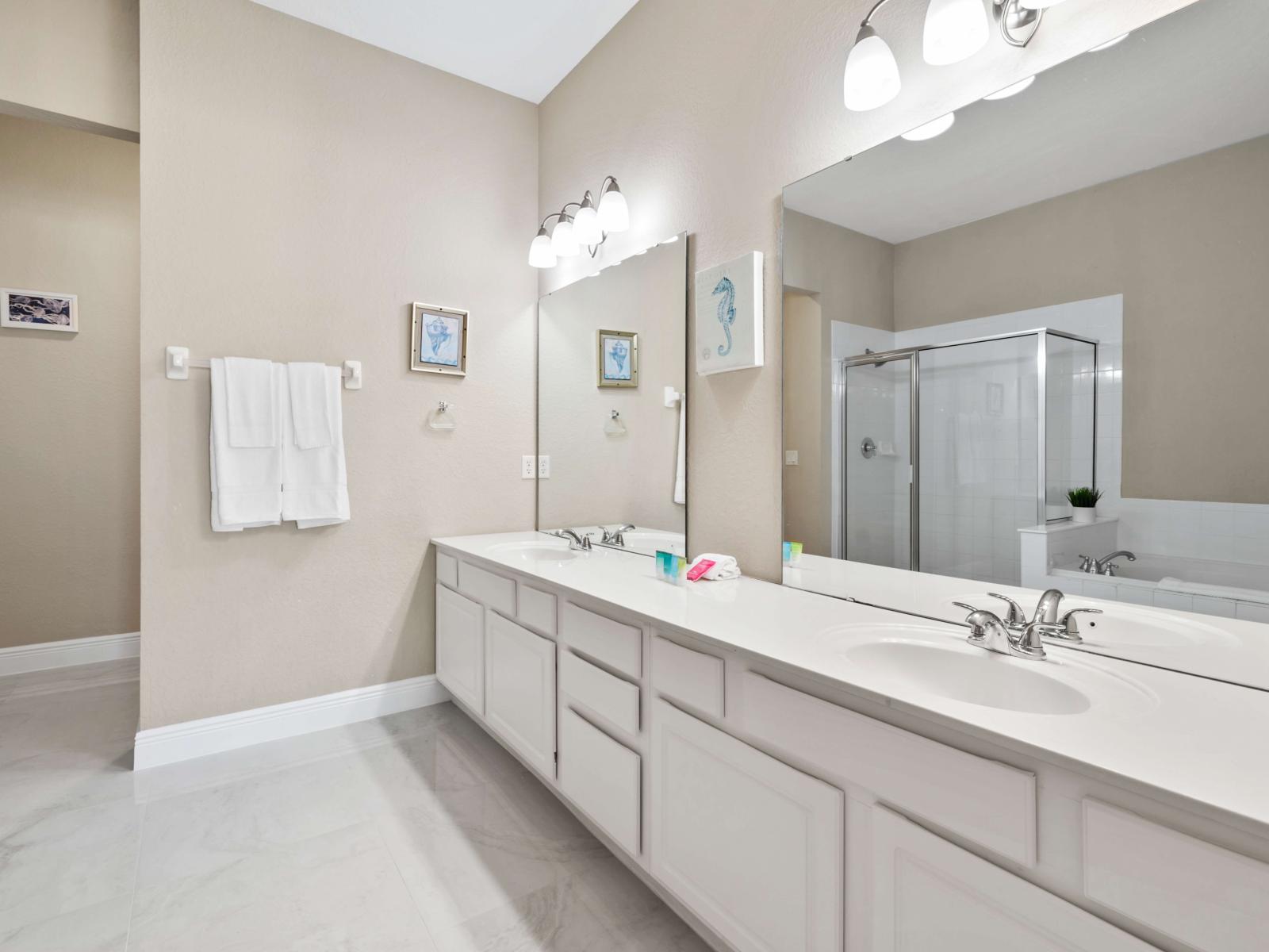 Private bathroom suite with a bathtub and a walk- in shower