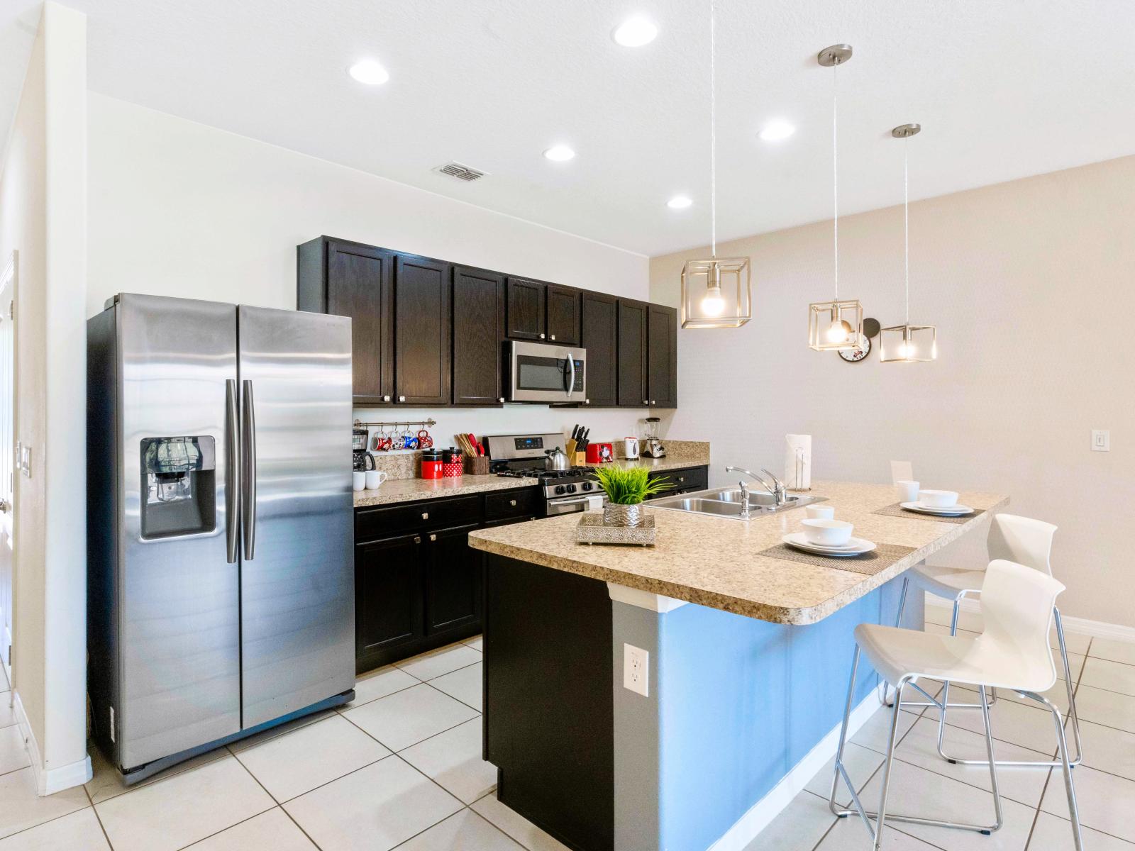 Lofty kitchen of the townhouse in Davenport Florida - Functional layout designed for efficient meal preparation - Plenty storage space for organized and clutter-free counters - Breakfast bar and high chairs