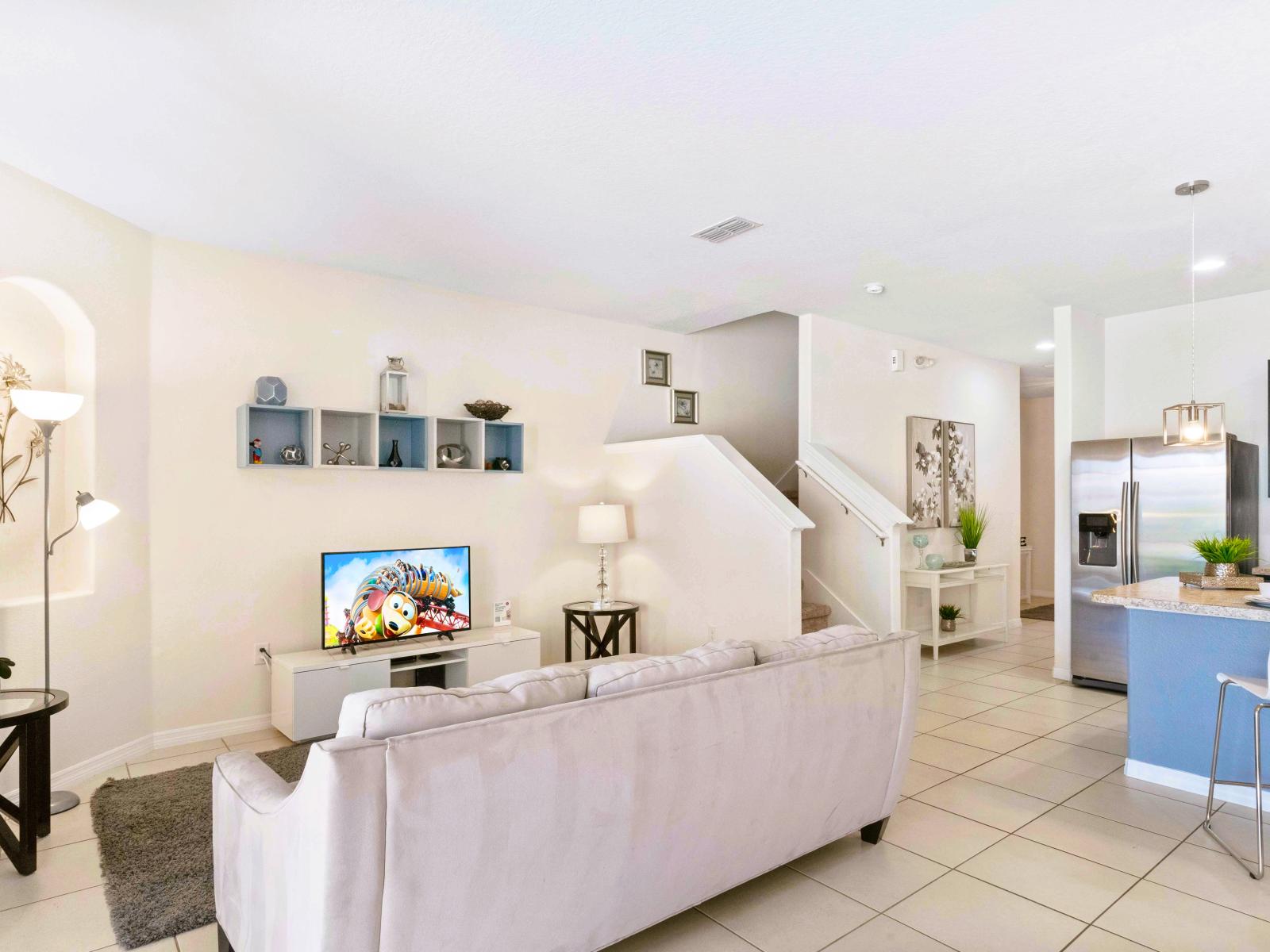 Well-designed living area of the townhouse in Davenport Florida - Harmonious blend of textures and materials - Smart TV for entertainment - Smart use of space with multifunctional furniture for a practical yet beautiful environment