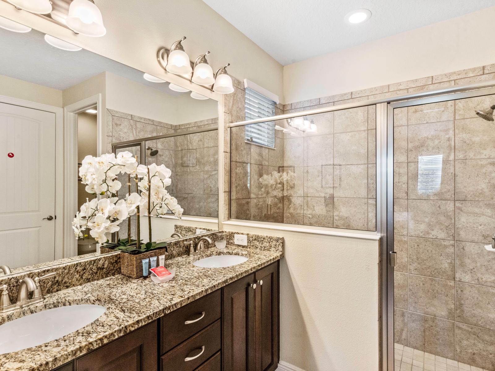 Lavish Bathroom of the Home in Kissimmee Florida - Boasts Double Vanity and Large Mirror - Spacious Shower Stall for Ultimate Comfort