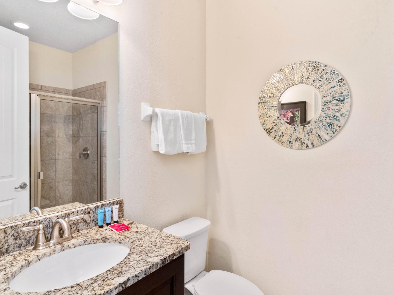 Serene Bathroom of the Home in Kissimmee Florida - Offering a private and tranquil space for unwinding  - Chic Vanity with upscale lighting