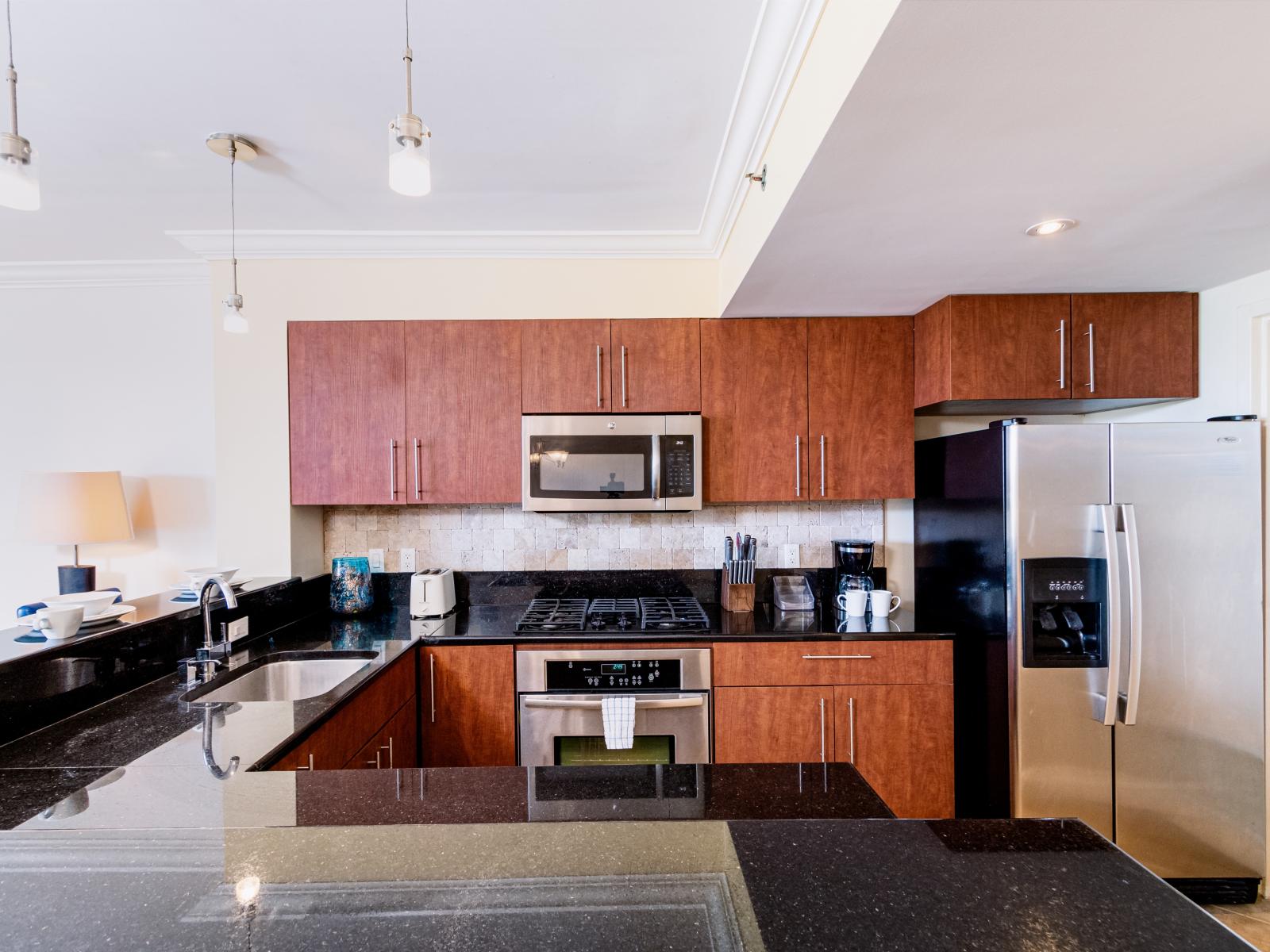 Outstanding and fully equipped kitchen of the condo in Noord Aruba - Availability of all kitchen accessories - Elegant lighting - Large amount of storage - Sufficient space to walk and work according to your ease