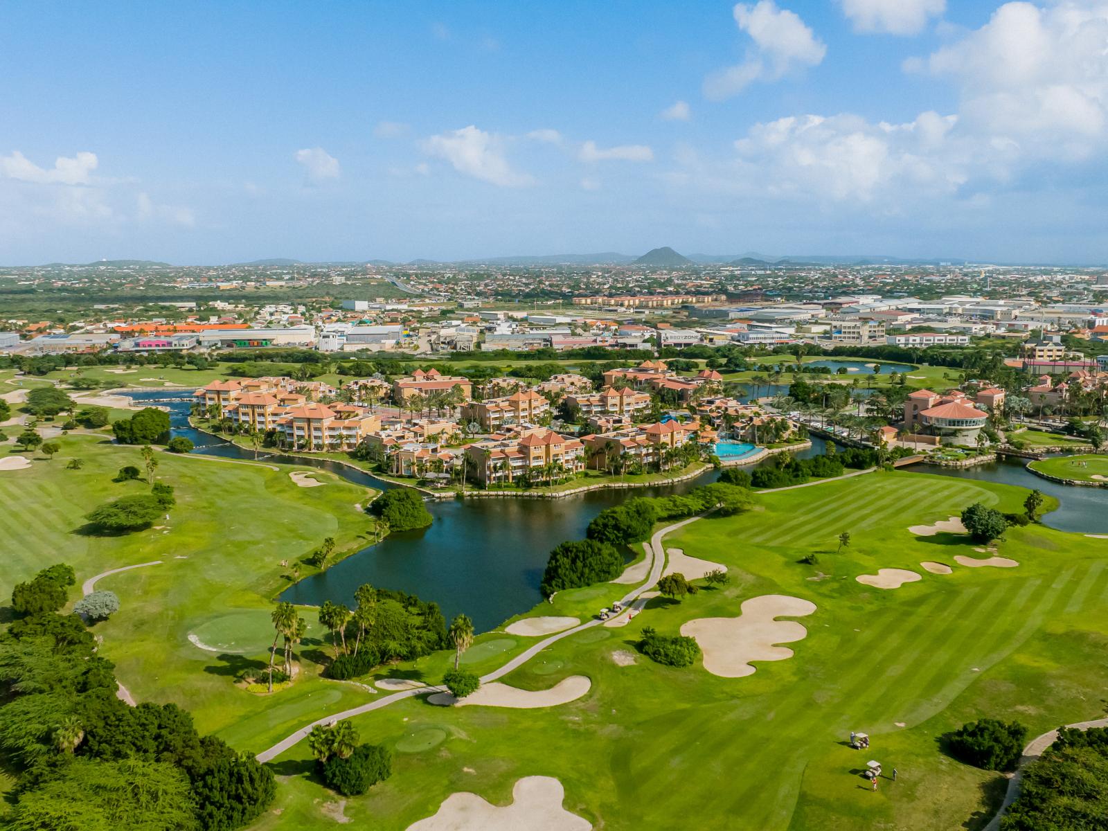 Escape to serenity: Divi Village Golf Course invites you to experience the tranquil beauty of Noord Aruba, with refreshing greenery and captivating views that make every swing a delight.