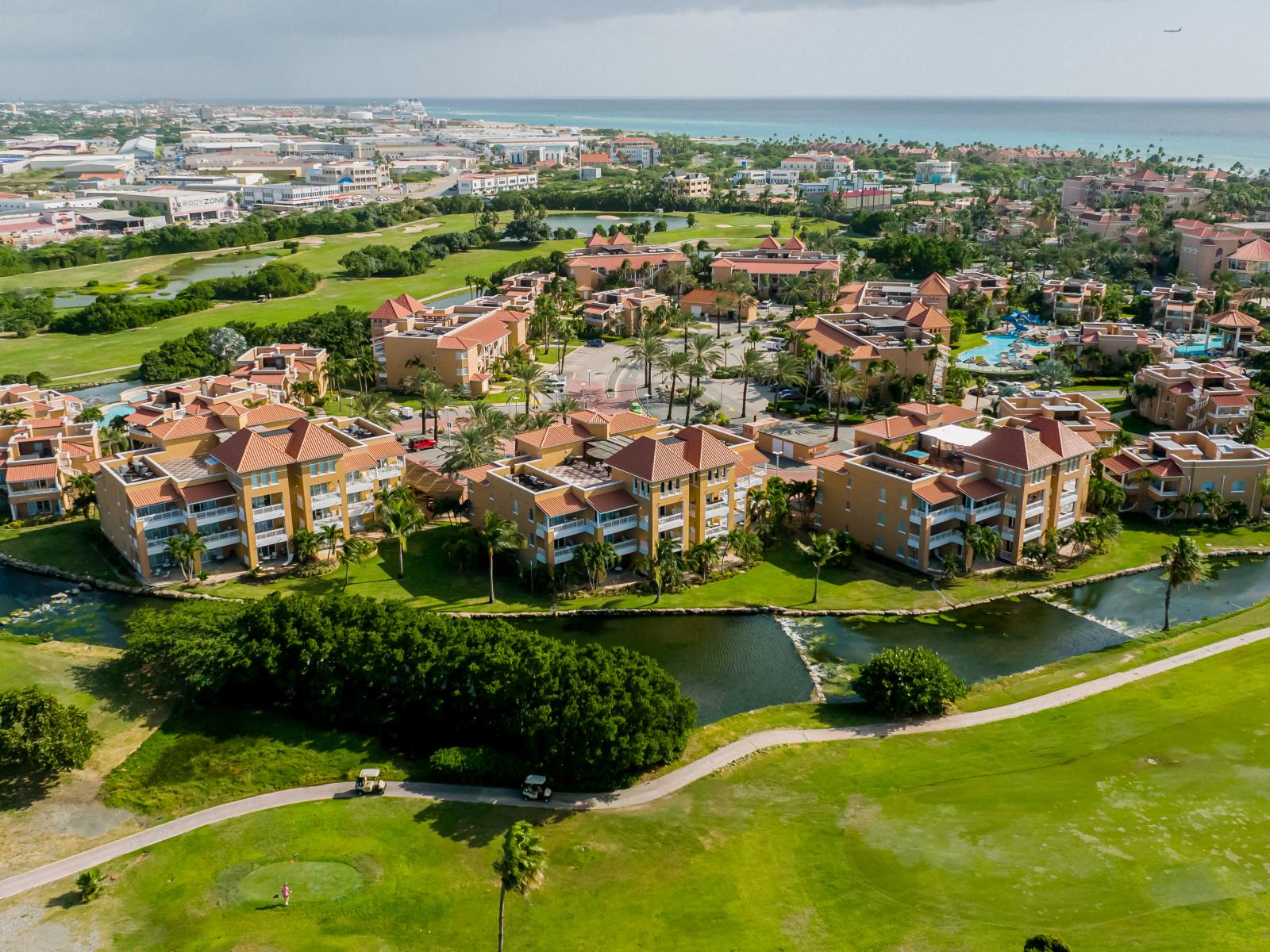 Indulge in serenity at the Divi Village pool in Noord, Aruba, where beautiful lakeside views, superb design, and a refreshing environment converge to create a vibrant atmosphere, perfect for unwinding in paradise.