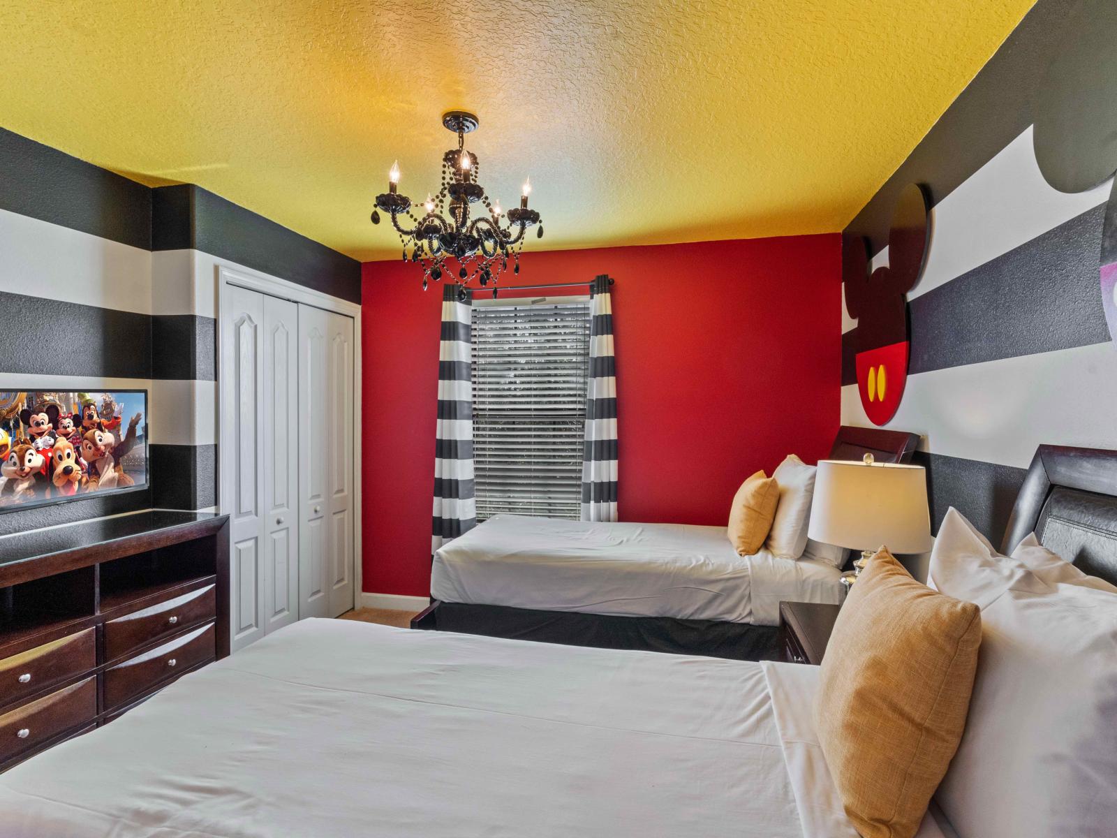 The Mickey Mouse  themed wall in the bedroom  transforms the space  into a realm of enchantment.