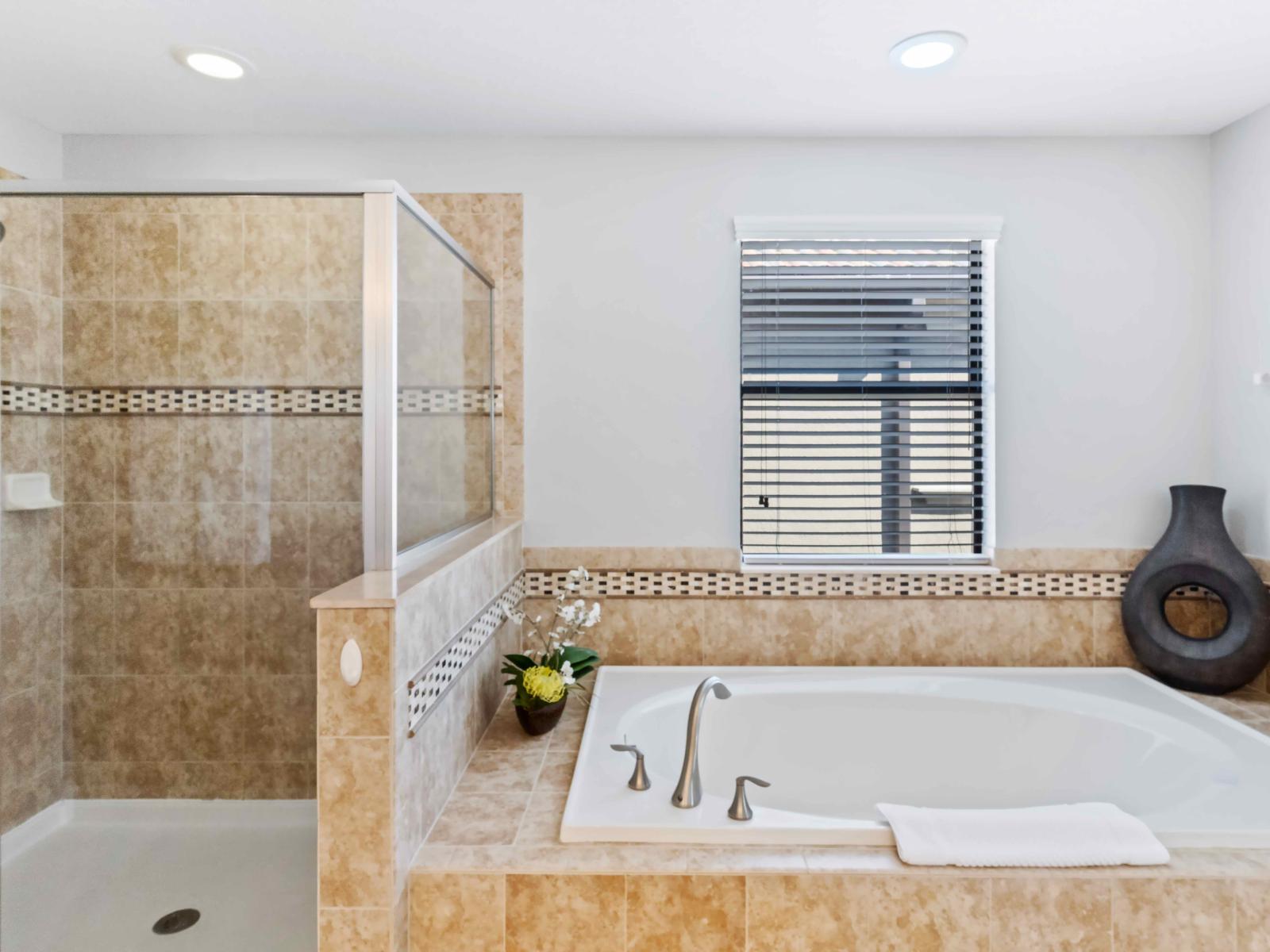 Shower and bath tub :  With modern fixtures, spacious design, and soothing ambiance, it offers guests a tranquil retreat where they can wash away the day's cares and emerge feeling renewed and invigorated, ensuring a delightful stay.