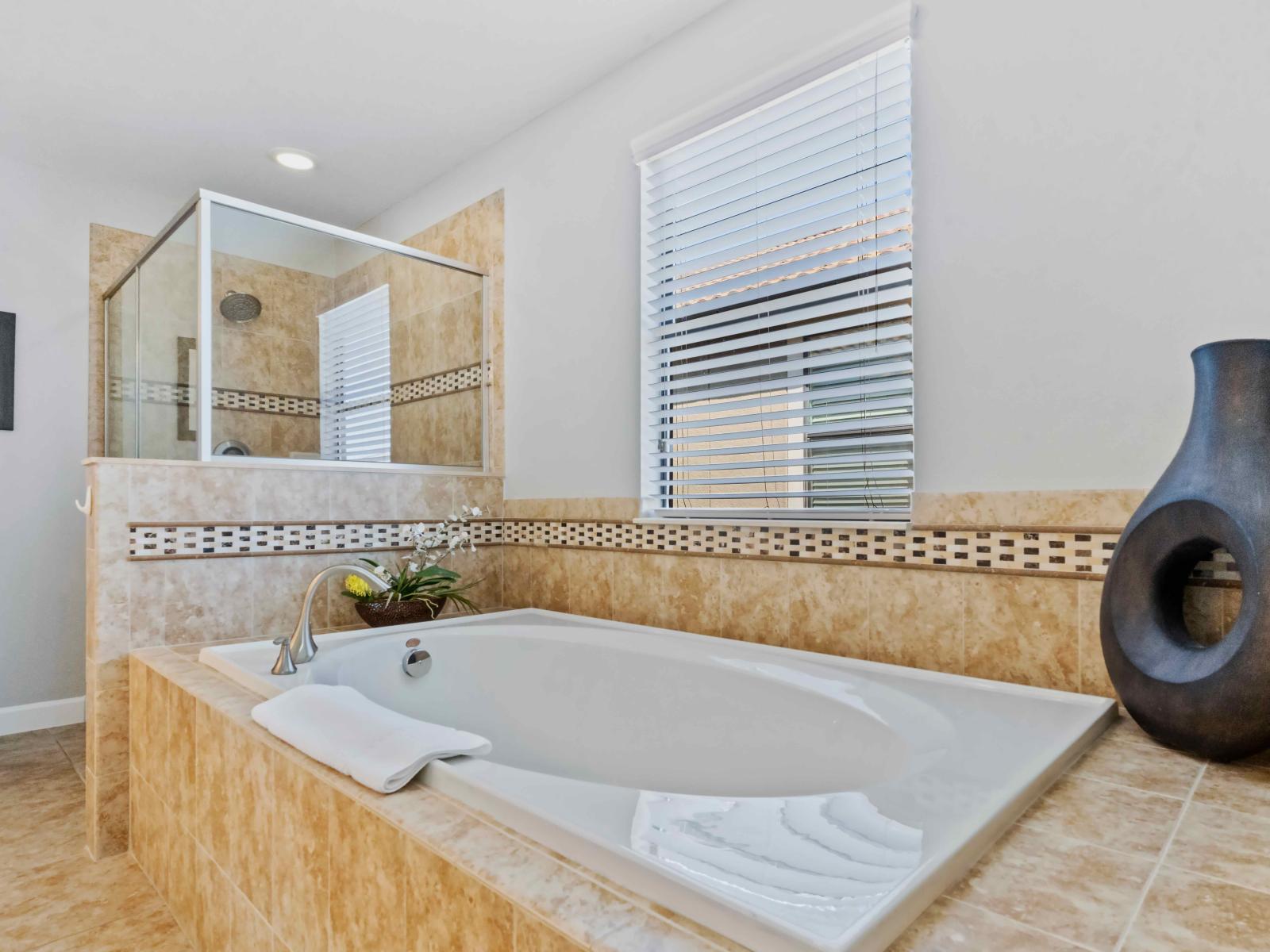 The bath tub offers guests a tranquil retreat where guests can unwind and indulge in a soothing soak, creating moments of blissful relaxation and rejuvenation during their stay.