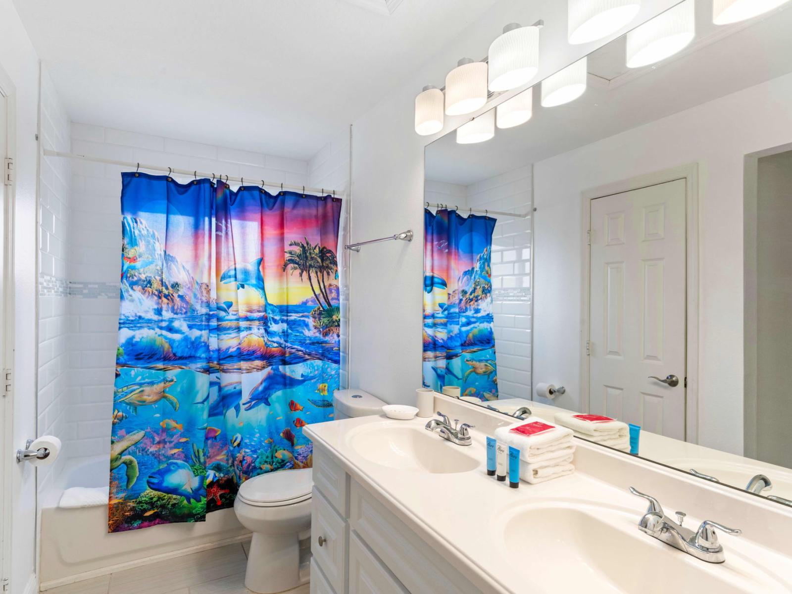 Chic Bathroom of the apartment in Kissimmee - Beautiful Vanity with large size wall mirror - Sufficient storage space - Neat and clean toilet seat - Availability of all bathroom amenities - Stunning glass cabin shower area - Neat and cosy Bathtub