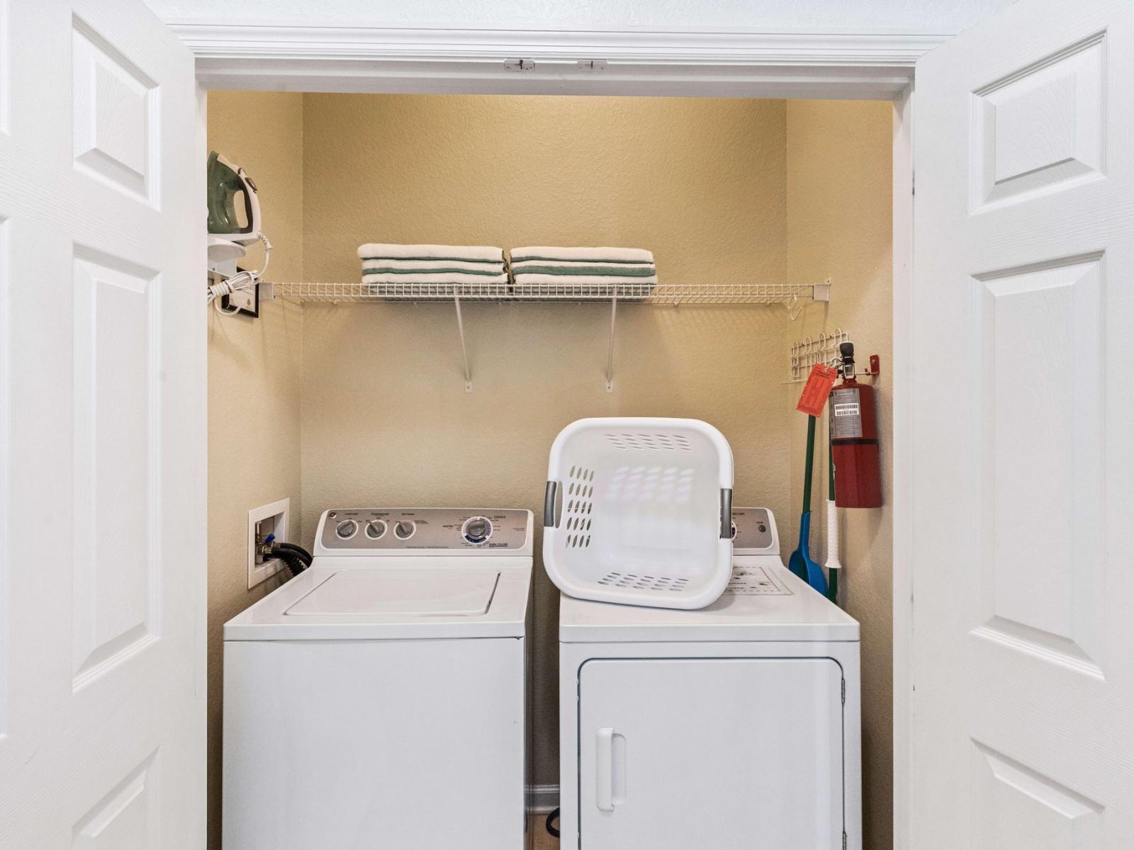 The laundry area boasts a full-size washer and dryer, ensuring that you can easily keep your clothes fresh and clean throughout your stay.