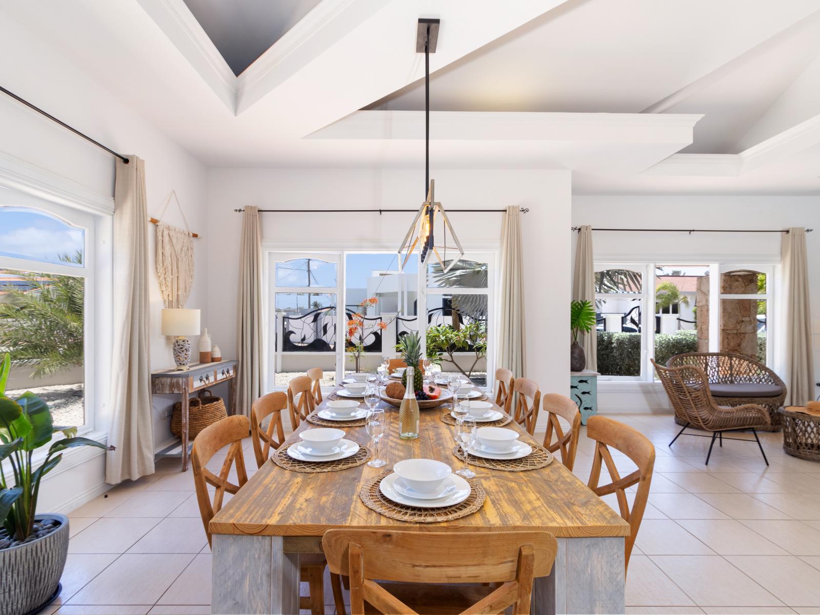 Elegant Dining Area of the Apartment in Noord Aruba - 10 Persons Dining - Thoughtful lighting fixtures creating an intimate and inviting atmosphere - Artfully arranged table settings for a touch of elegance