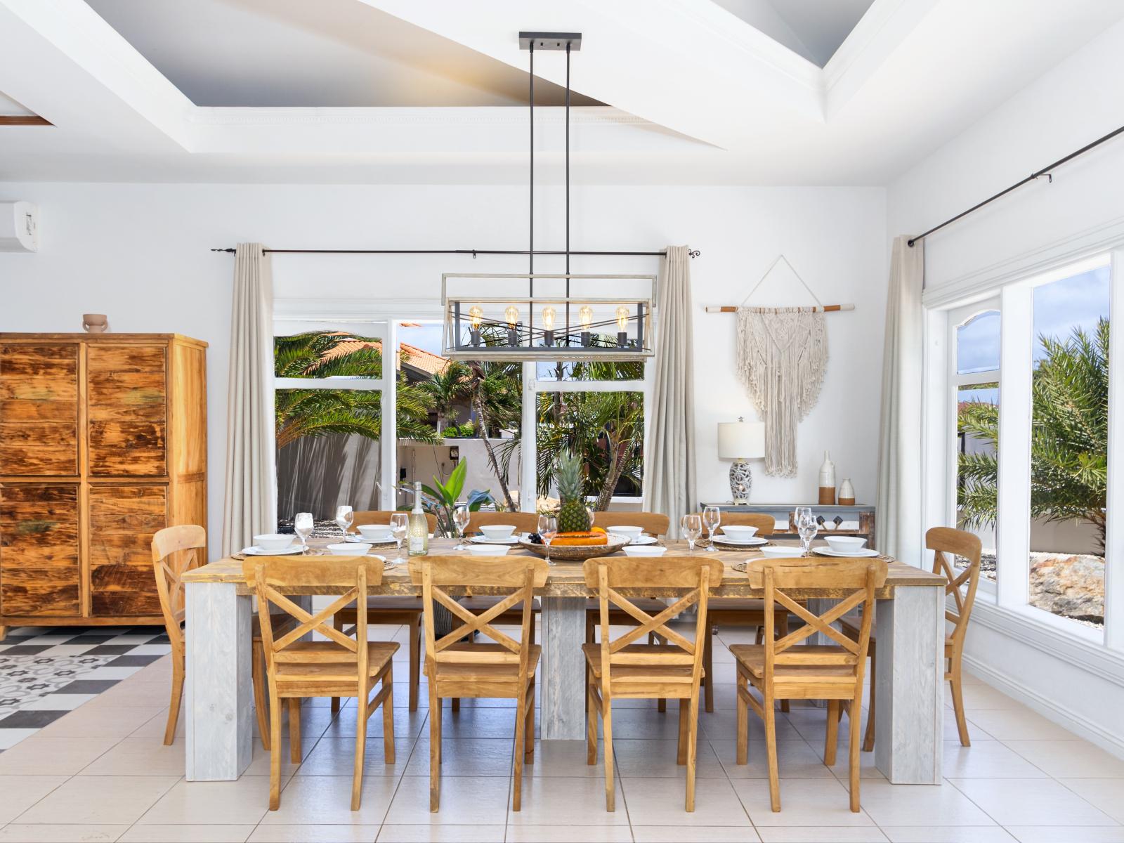 Chic Dining Area of the Apartment in Noord Aruba - Access to the backyard  - 10 Persons Dining - Thoughtful lighting fixtures creating an intimate and inviting atmosphere