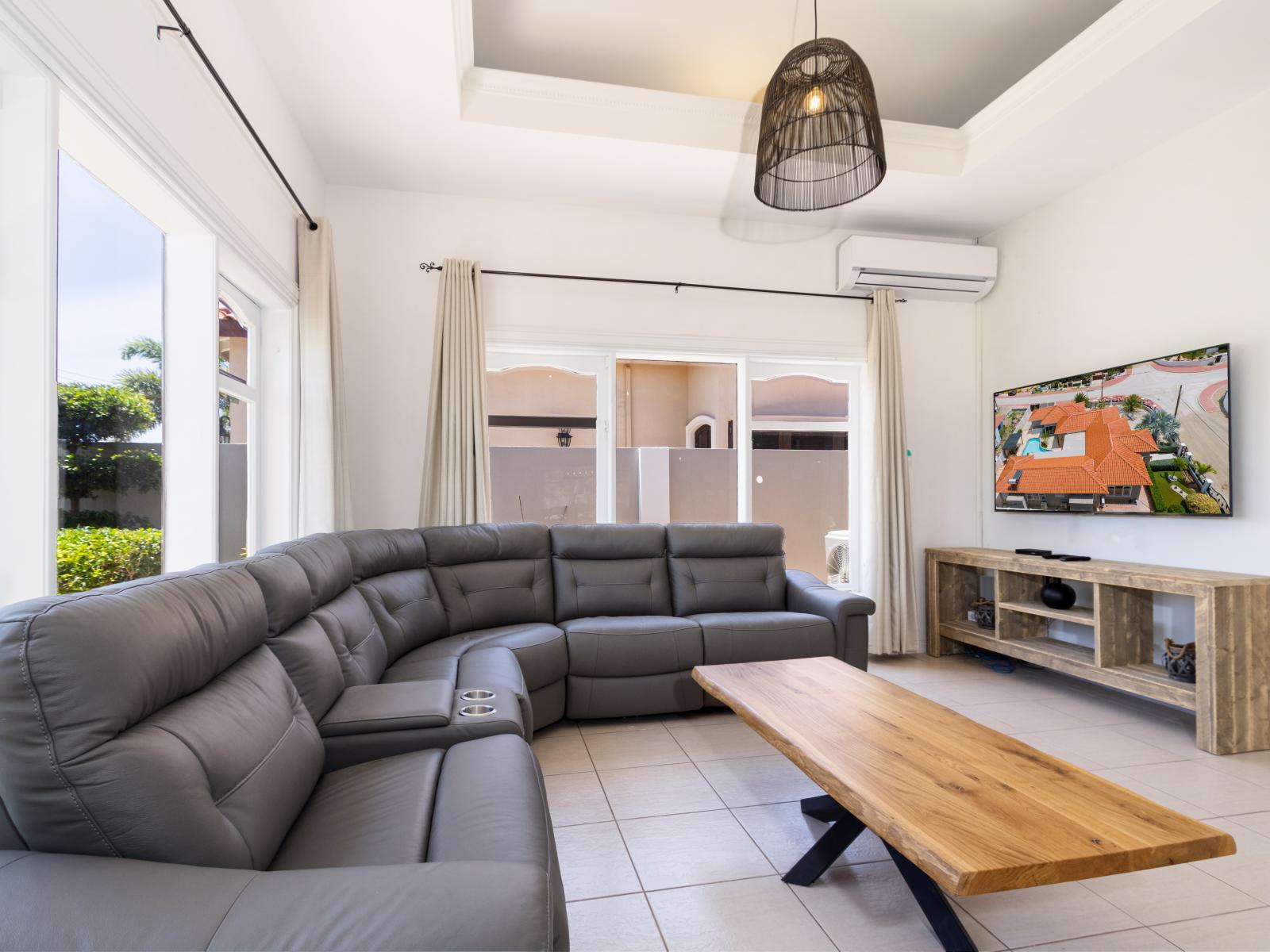 Living Area of the Apartment in Noord Aruba - Comfortable Sofa - Well-chosen lighting fixtures adding both functionality and charm - Smart TV and Netflix - Open-concept living area seamlessly connected to a stylish dining space
