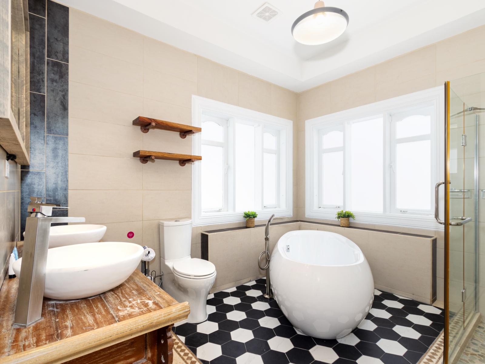 Lavish Bathroom of the Apartment in Noord Aruba - Double vanity - Chic Free Standing Bathtub - Glass enclosed walk-in shower area