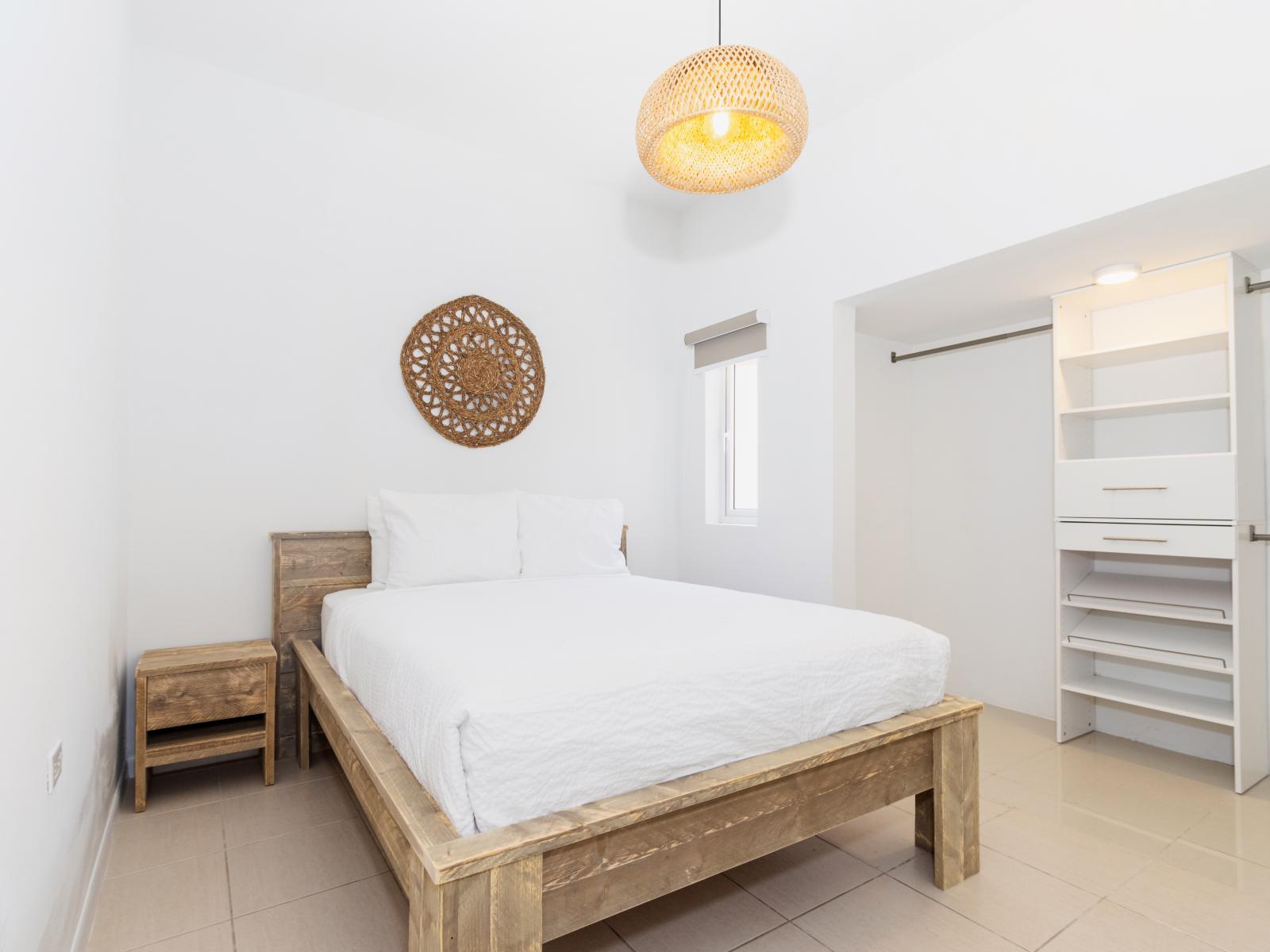 Comfy Bedroom of the Apartment in Noord Aruba - Queen size bed - Custom-built shelving ensures functionality - High-end finishes and refined details